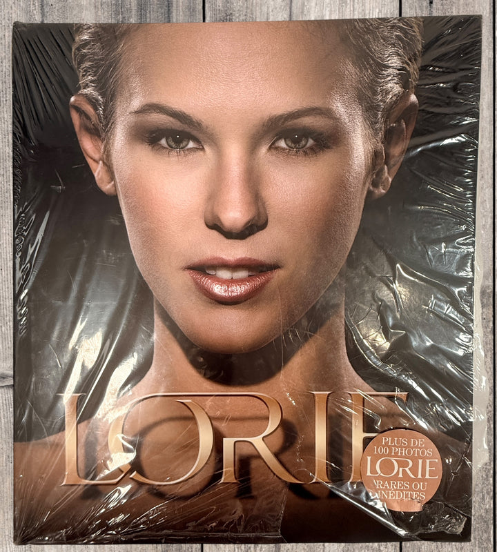 Sealed Lorie hardcover photo book featuring 100+ rare and unpublished images. Large-format French pop collector edition in excellent condition.