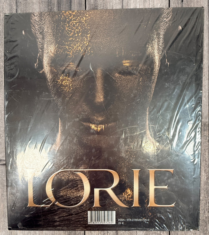 Sealed Lorie hardcover photo book featuring 100+ rare and unpublished images. Large-format French pop collector edition in excellent condition.