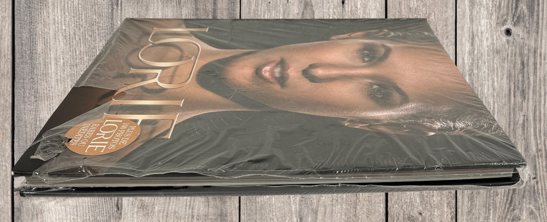 Sealed Lorie hardcover photo book featuring 100+ rare and unpublished images. Large-format French pop collector edition in excellent condition.