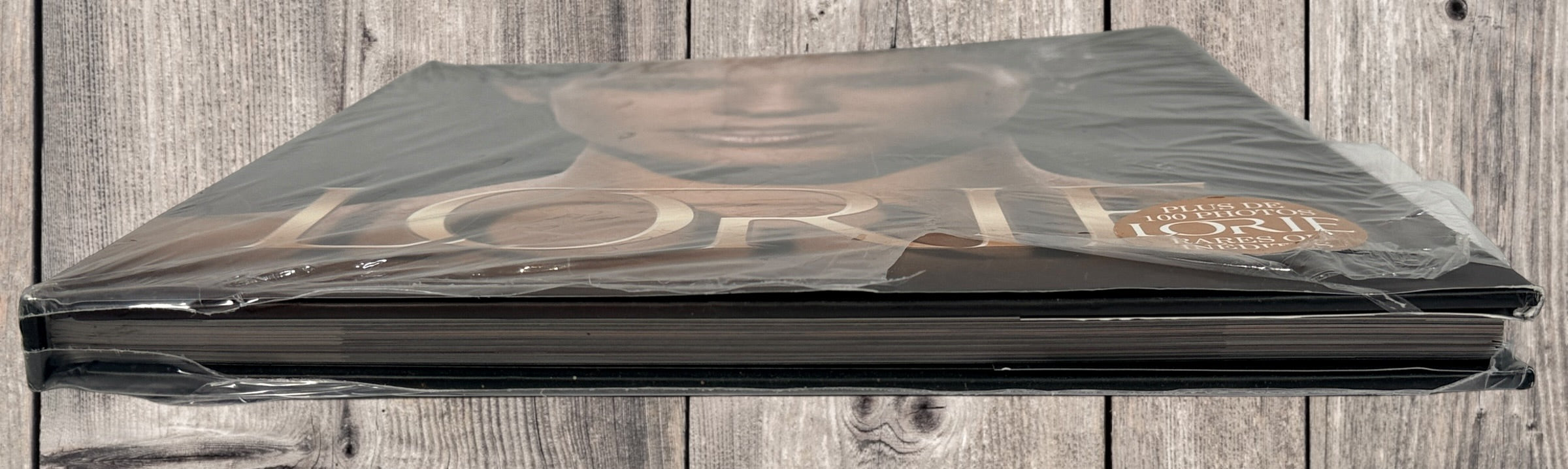 Sealed Lorie hardcover photo book featuring 100+ rare and unpublished images. Large-format French pop collector edition in excellent condition.