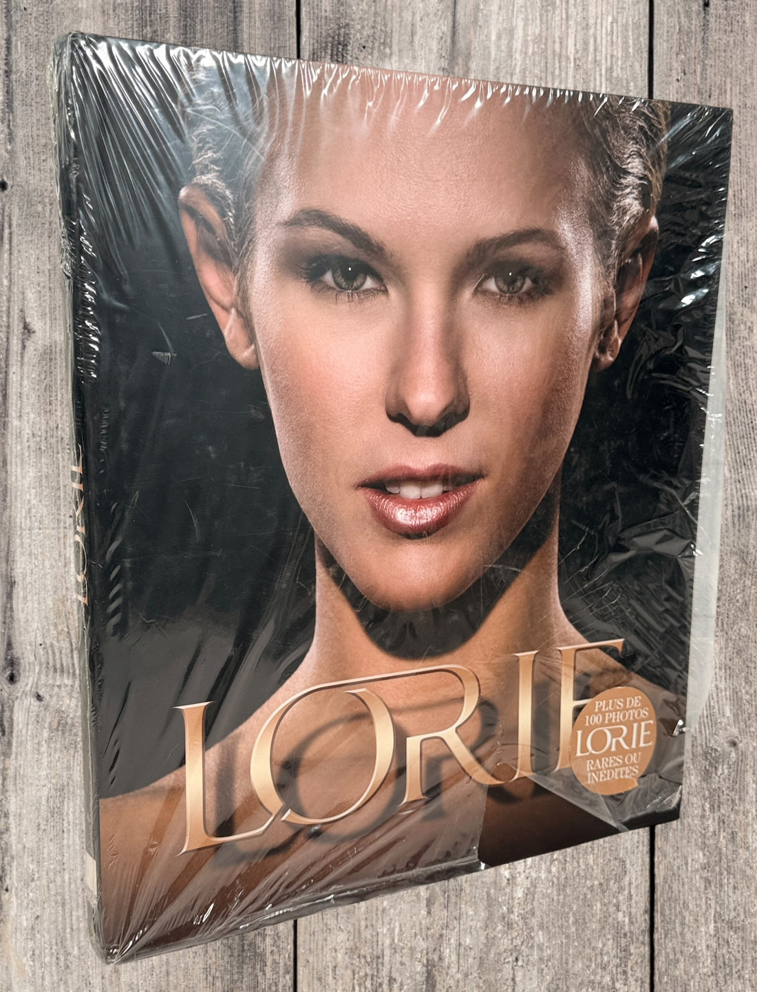 Sealed Lorie hardcover photo book featuring 100+ rare and unpublished images. Large-format French pop collector edition in excellent condition.