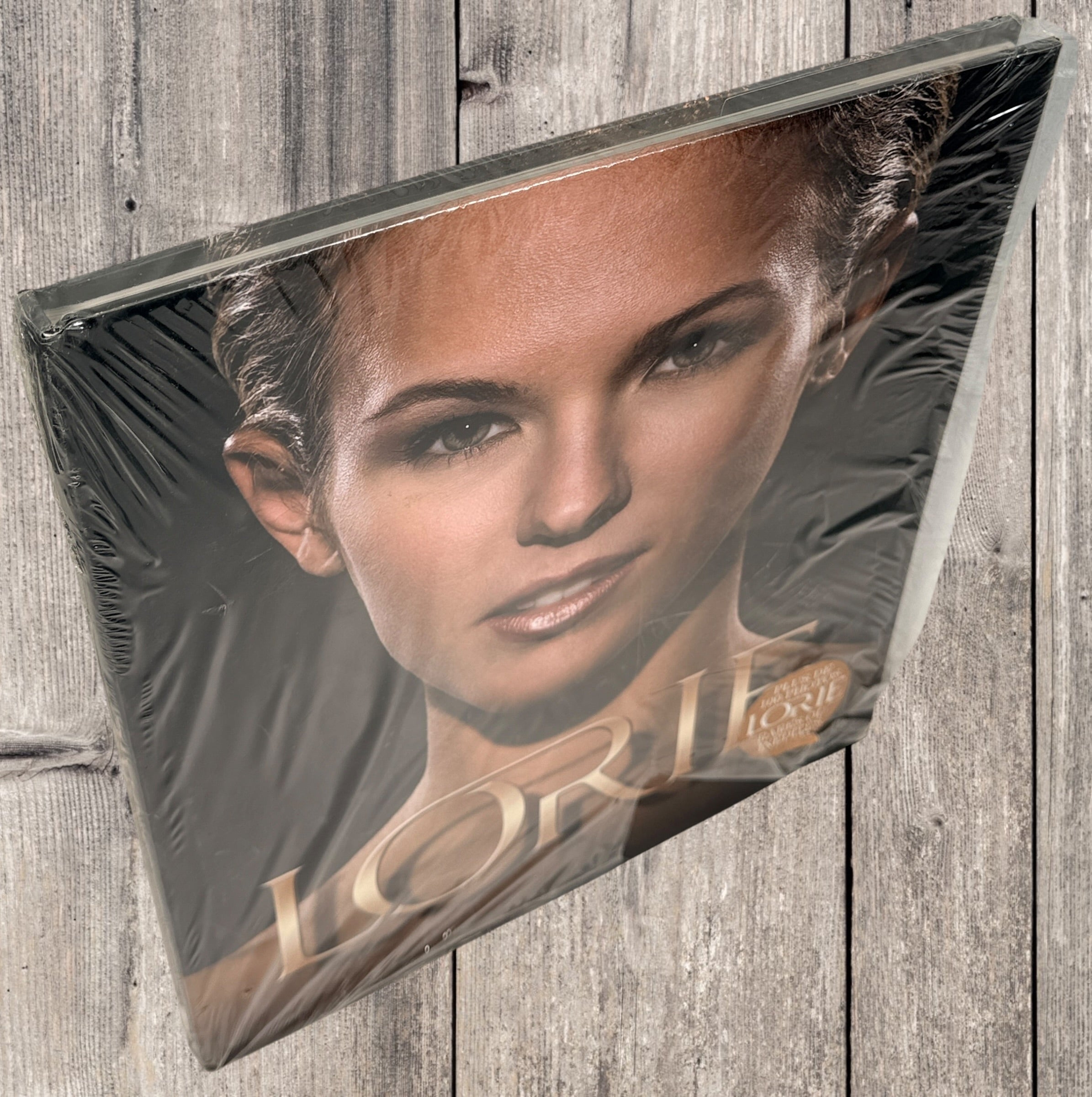 Sealed Lorie hardcover photo book featuring 100+ rare and unpublished images. Large-format French pop collector edition in excellent condition.