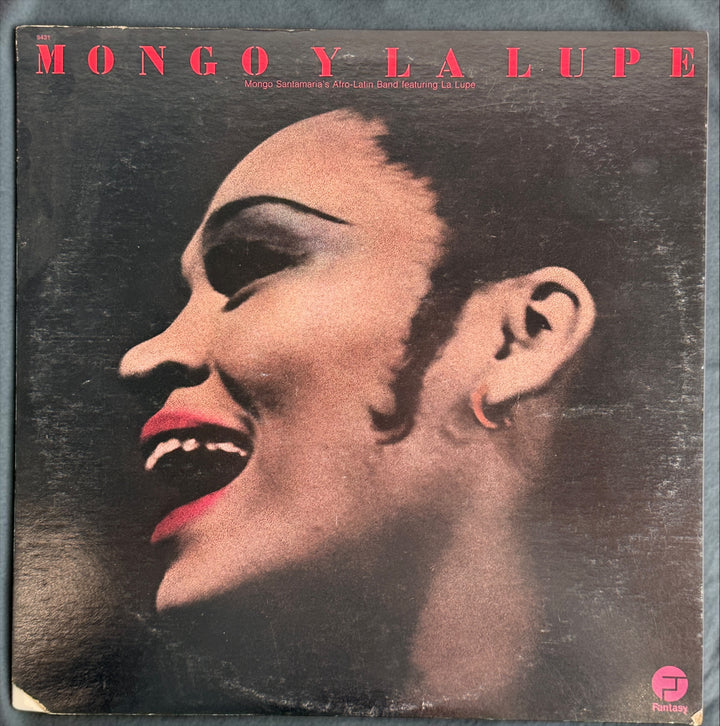 Discover Mongo y La Lupe, a 1973 pressing featuring Mongo Santamaria’s Afro-Latin Band and La Lupe. Vibrant Latin jazz and Afro-Cuban rhythms on vintage vinyl.