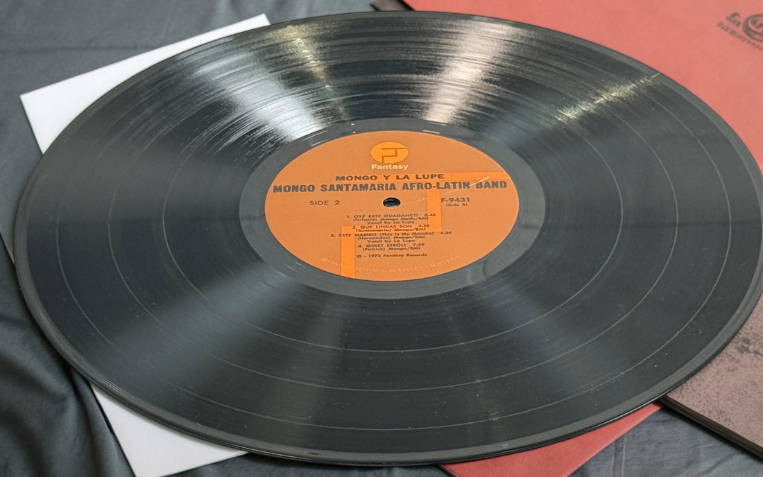 Discover Mongo y La Lupe, a 1973 pressing featuring Mongo Santamaria’s Afro-Latin Band and La Lupe. Vibrant Latin jazz and Afro-Cuban rhythms on vintage vinyl.