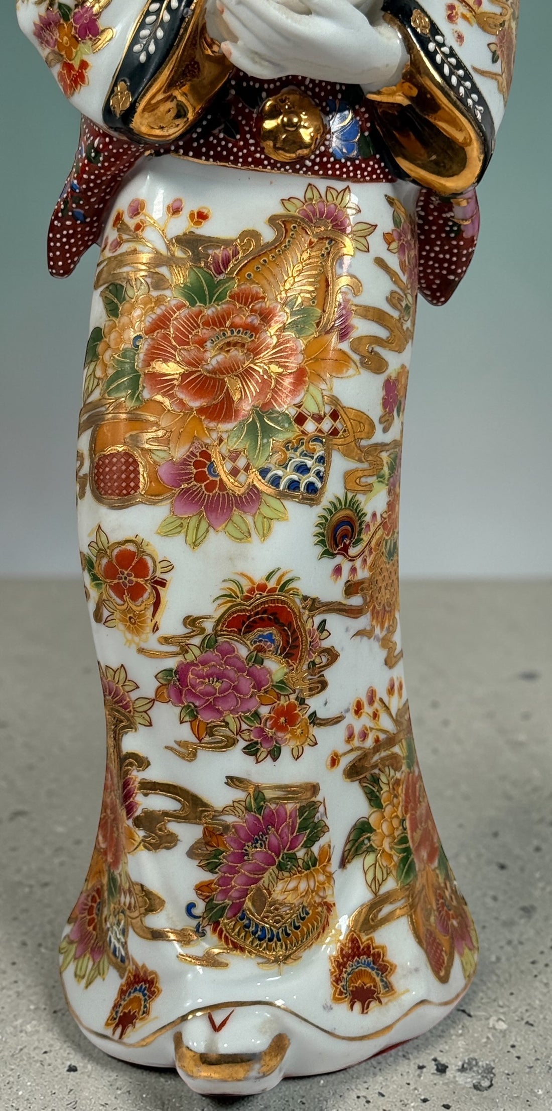 Vintage Japanese porcelain geisha figurine with hand-painted florals and raised gilt moriage detail. Elegant mid-century decorative display piece
