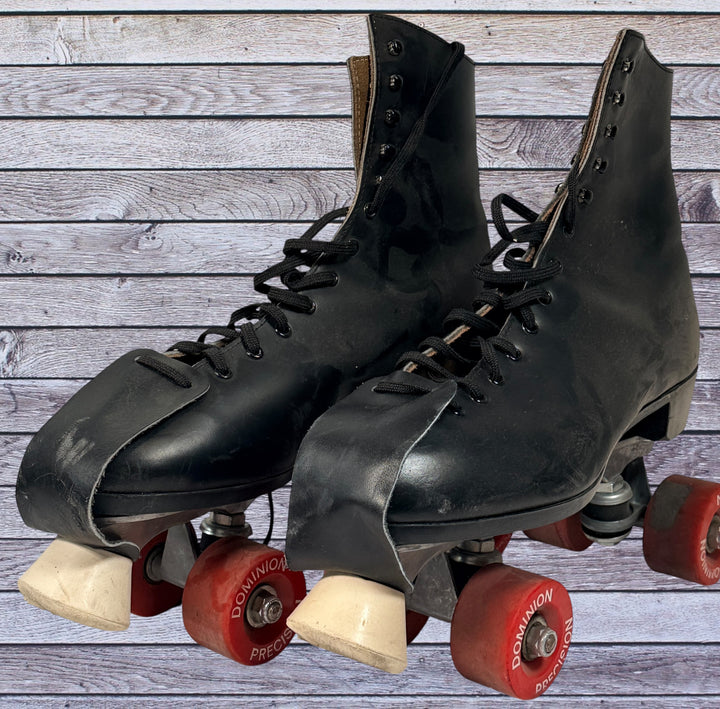 Vintage Dominion Canada leather roller skates, black quad setup with original Dominion Precision wheels. Classic rink style, estimated men’s size 10.