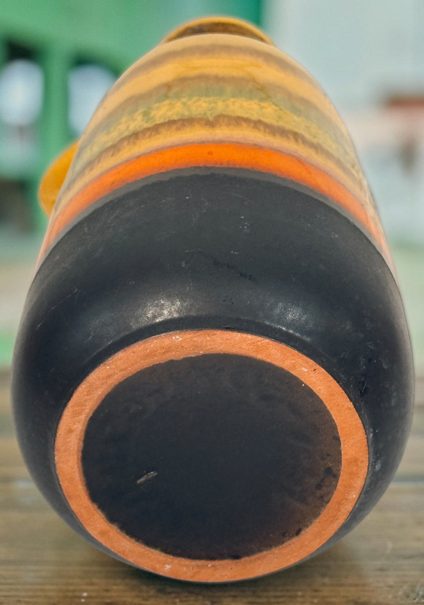 Vintage 1970s West German pottery vase marked 153L-20 with loop handle and colourful mustard, orange, green and brown striped glaze.