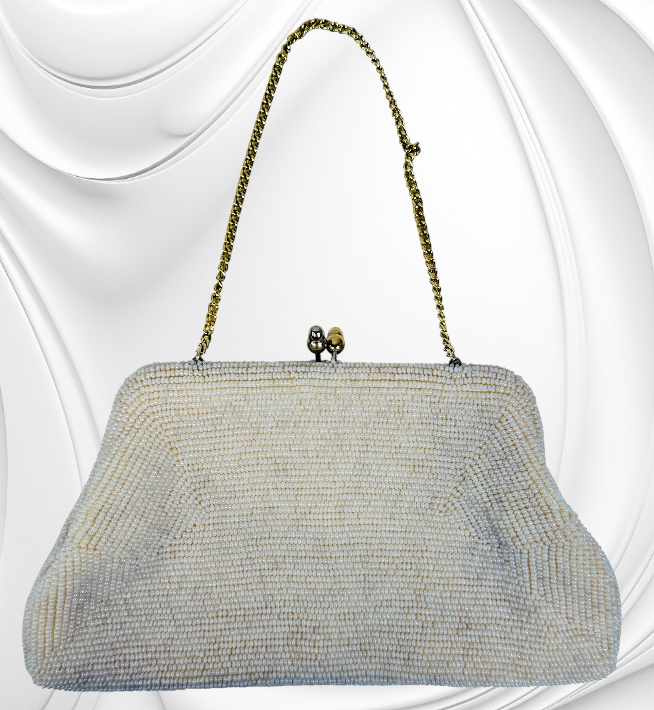 Vintage Birks white beaded evening clutch made in Japan with gold frame and chain strap. Elegant bridal or formal handbag in very good condition.
