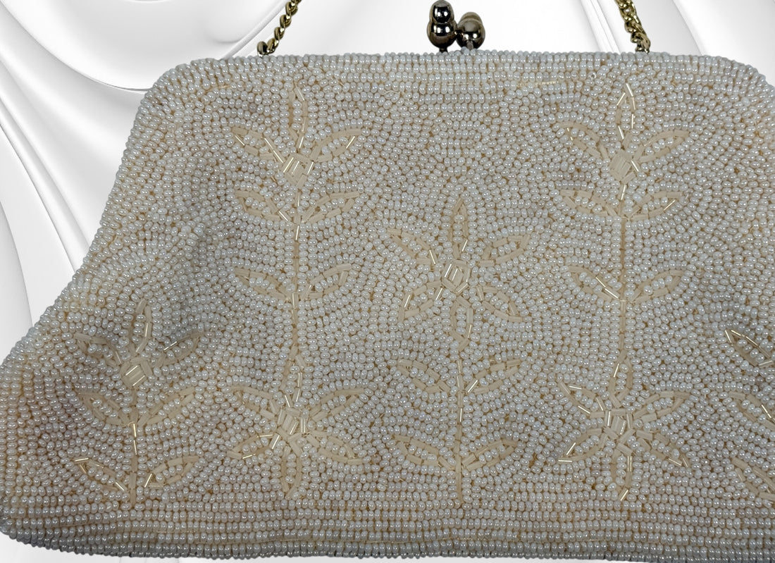 Vintage Birks white beaded evening clutch made in Japan with gold frame and chain strap. Elegant bridal or formal handbag in very good condition.
