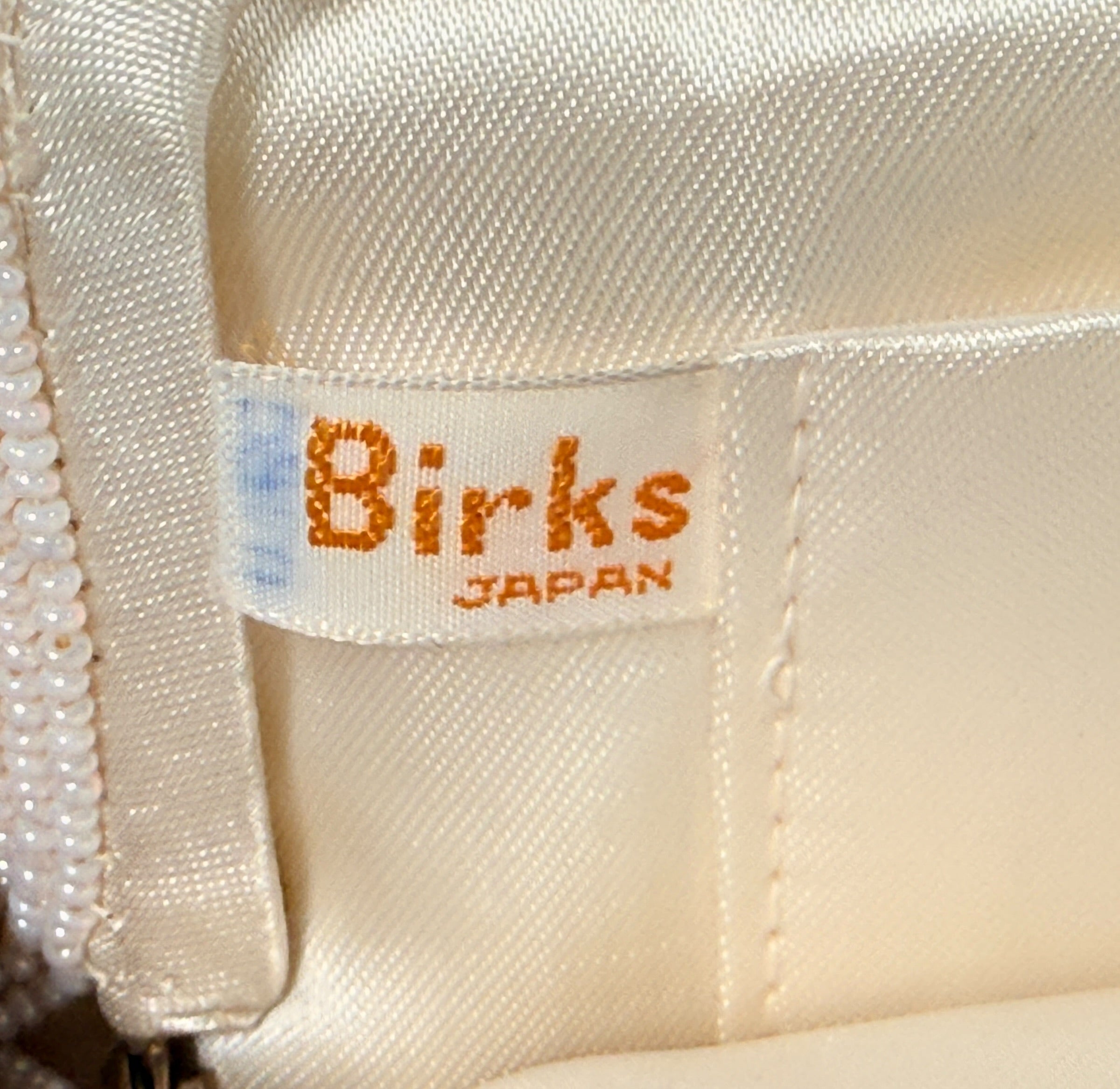 Vintage Birks white beaded evening clutch made in Japan with gold frame and chain strap. Elegant bridal or formal handbag in very good condition.