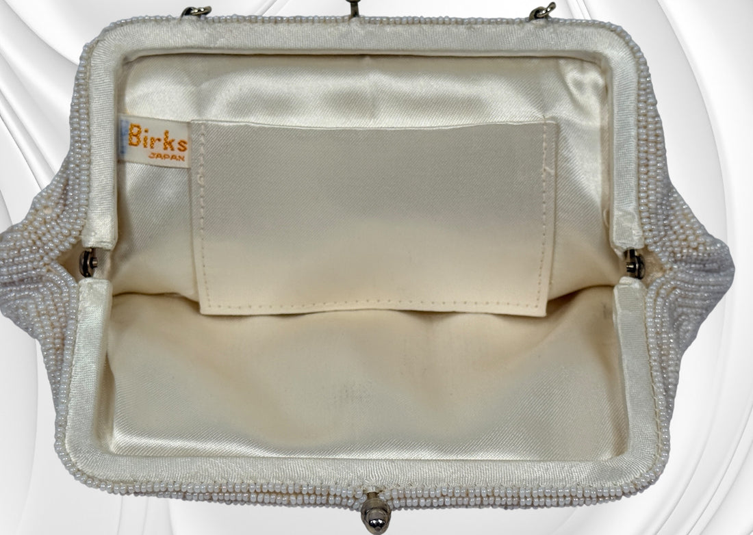 Vintage Birks white beaded evening clutch made in Japan with gold frame and chain strap. Elegant bridal or formal handbag in very good condition.