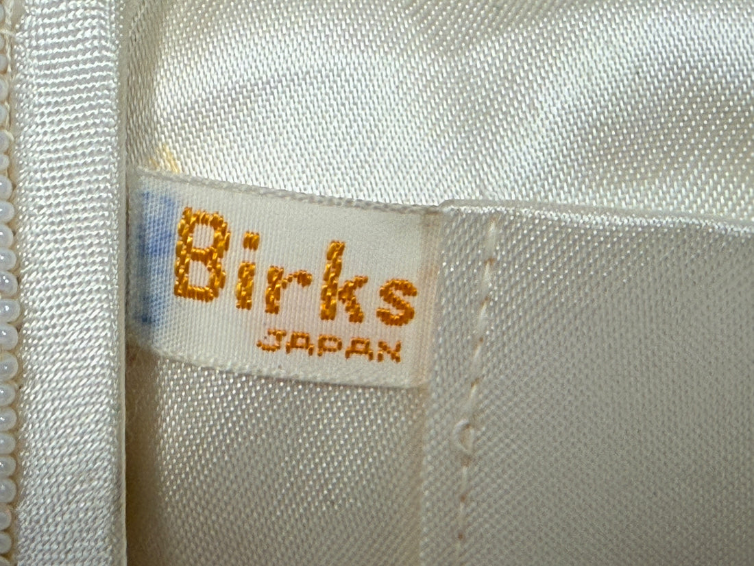 Vintage Birks white beaded evening clutch made in Japan with gold frame and chain strap. Elegant bridal or formal handbag in very good condition.