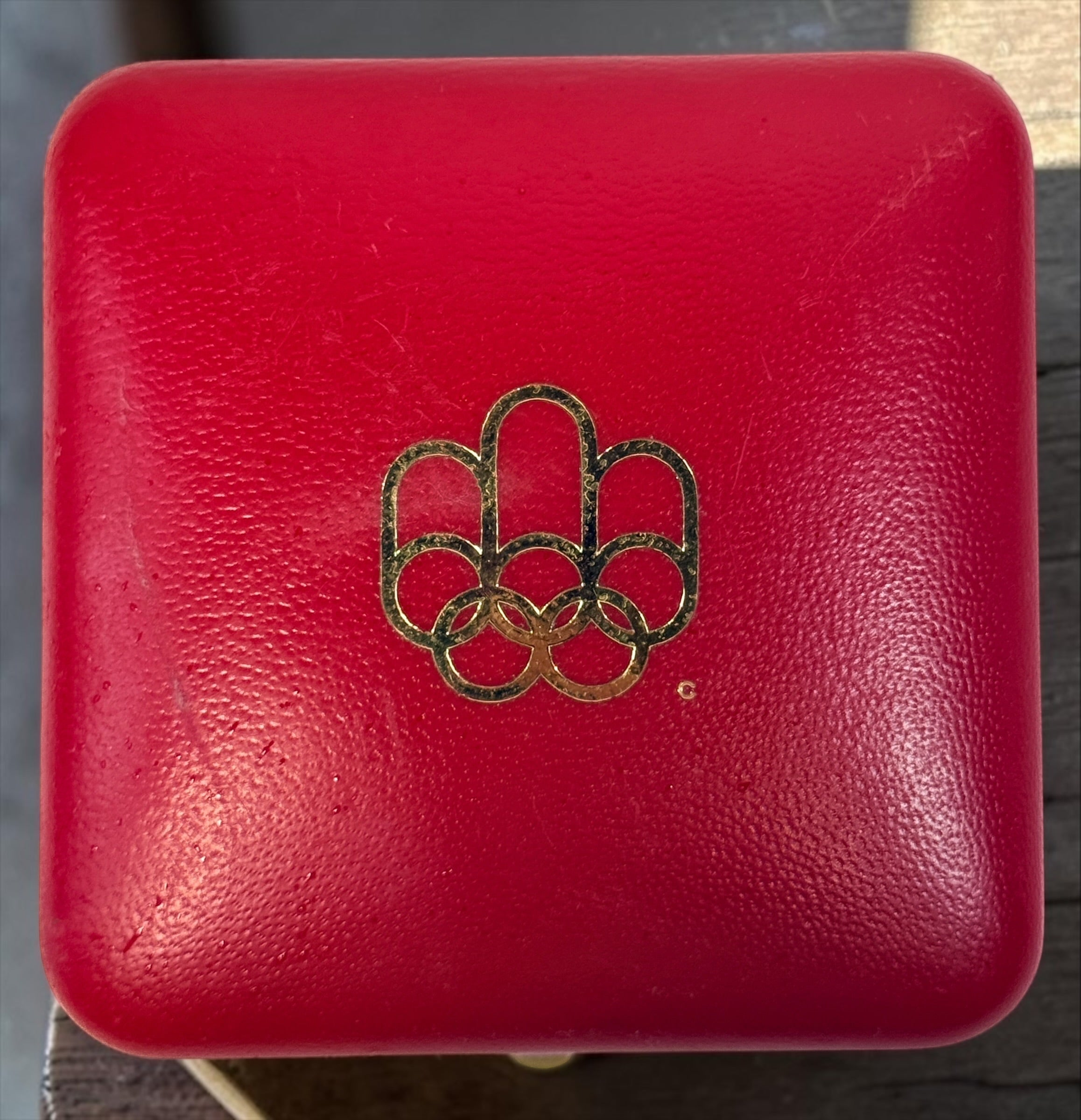 Official 1976 Montréal Olympics bronze medallion by Huguenin Switzerland with original red case and numbered COA #013824. Vintage Olympic collectible.