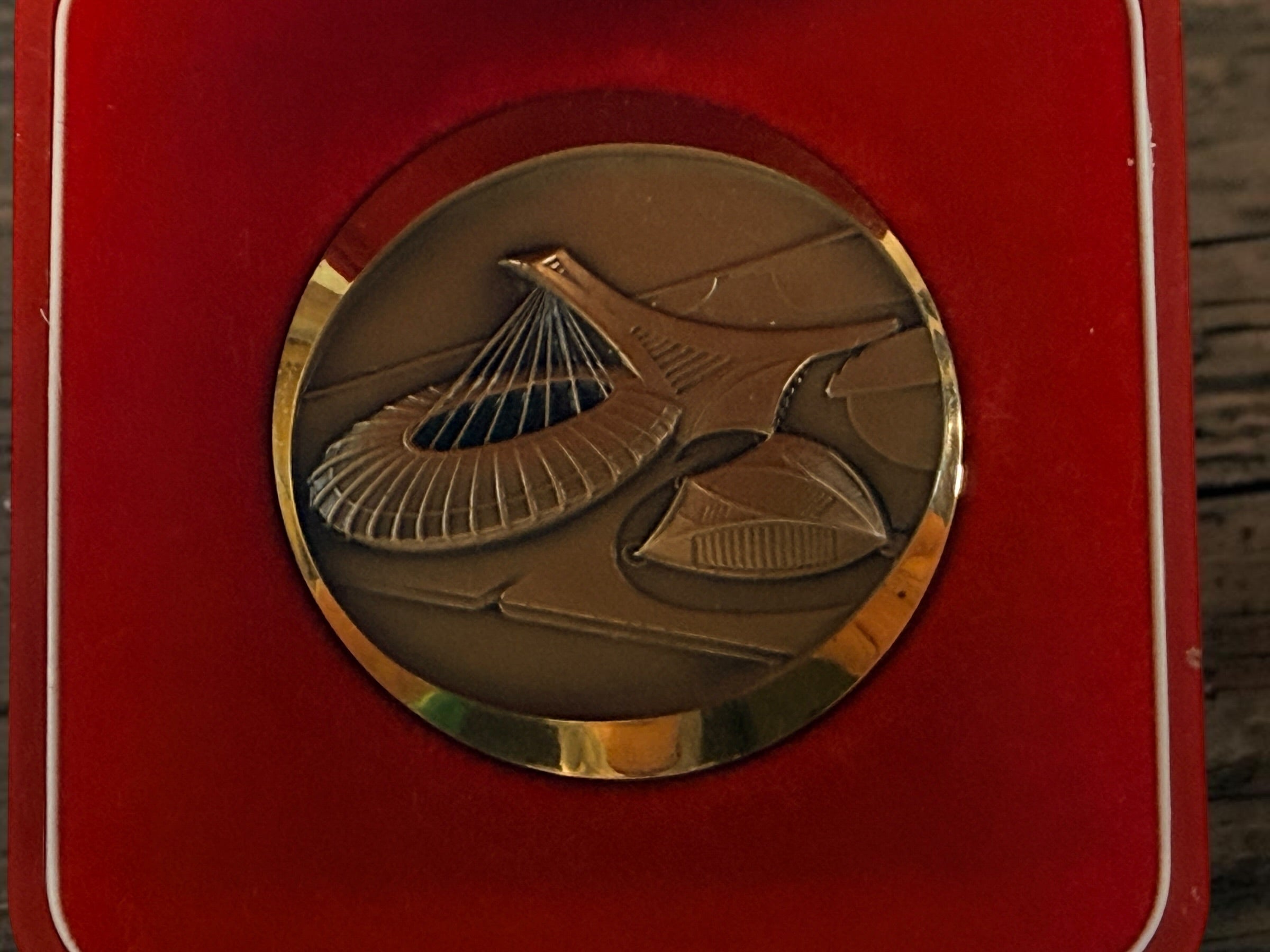 Official 1976 Montréal Olympics bronze medallion by Huguenin Switzerland with original red case and numbered COA #013824. Vintage Olympic collectible.