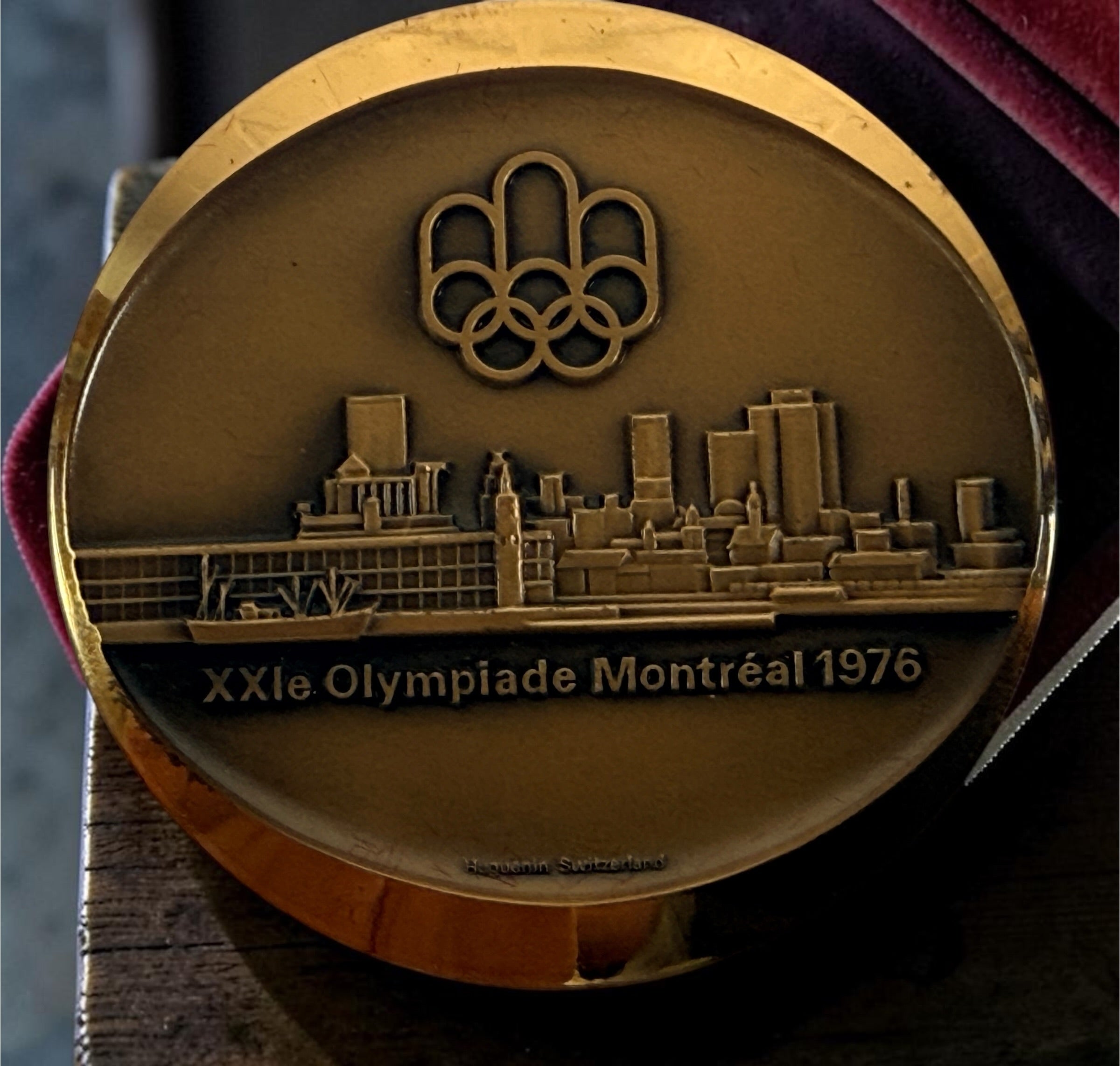 Official 1976 Montréal Olympics bronze medallion by Huguenin Switzerland with original red case and numbered COA #013824. Vintage Olympic collectible.