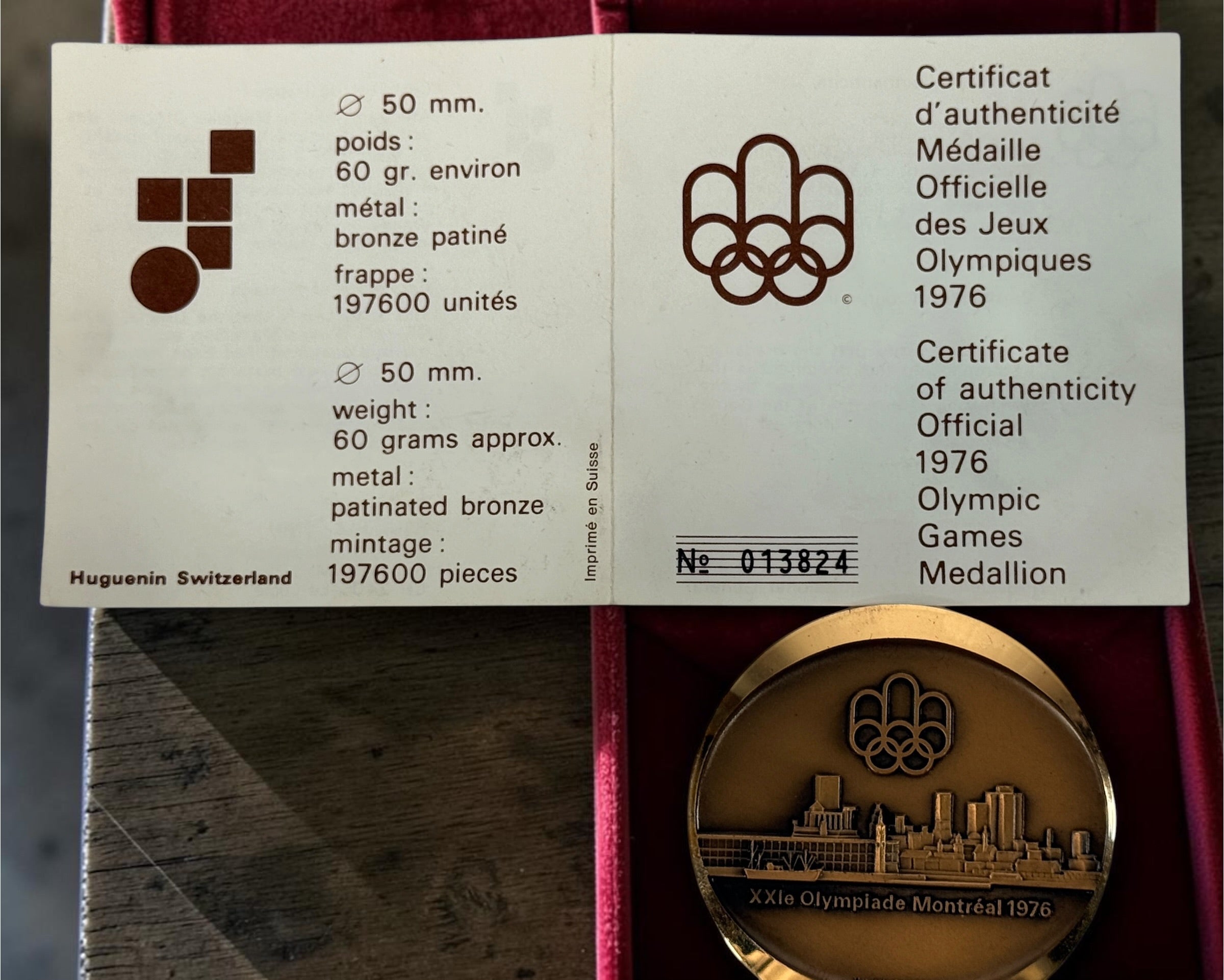 Official 1976 Montréal Olympics bronze medallion by Huguenin Switzerland with original red case and numbered COA #013824. Vintage Olympic collectible.