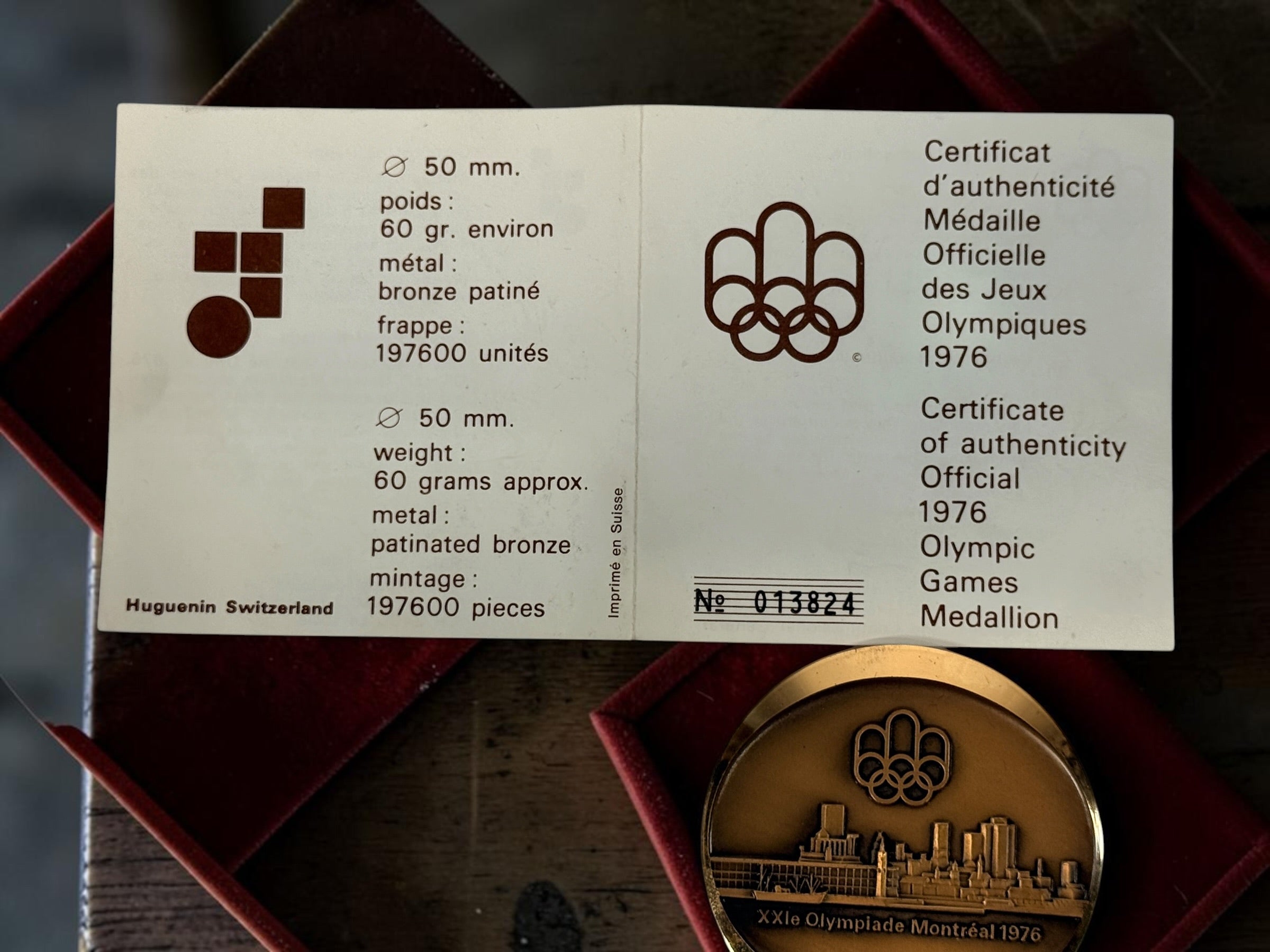 Official 1976 Montréal Olympics bronze medallion by Huguenin Switzerland with original red case and numbered COA #013824. Vintage Olympic collectible.