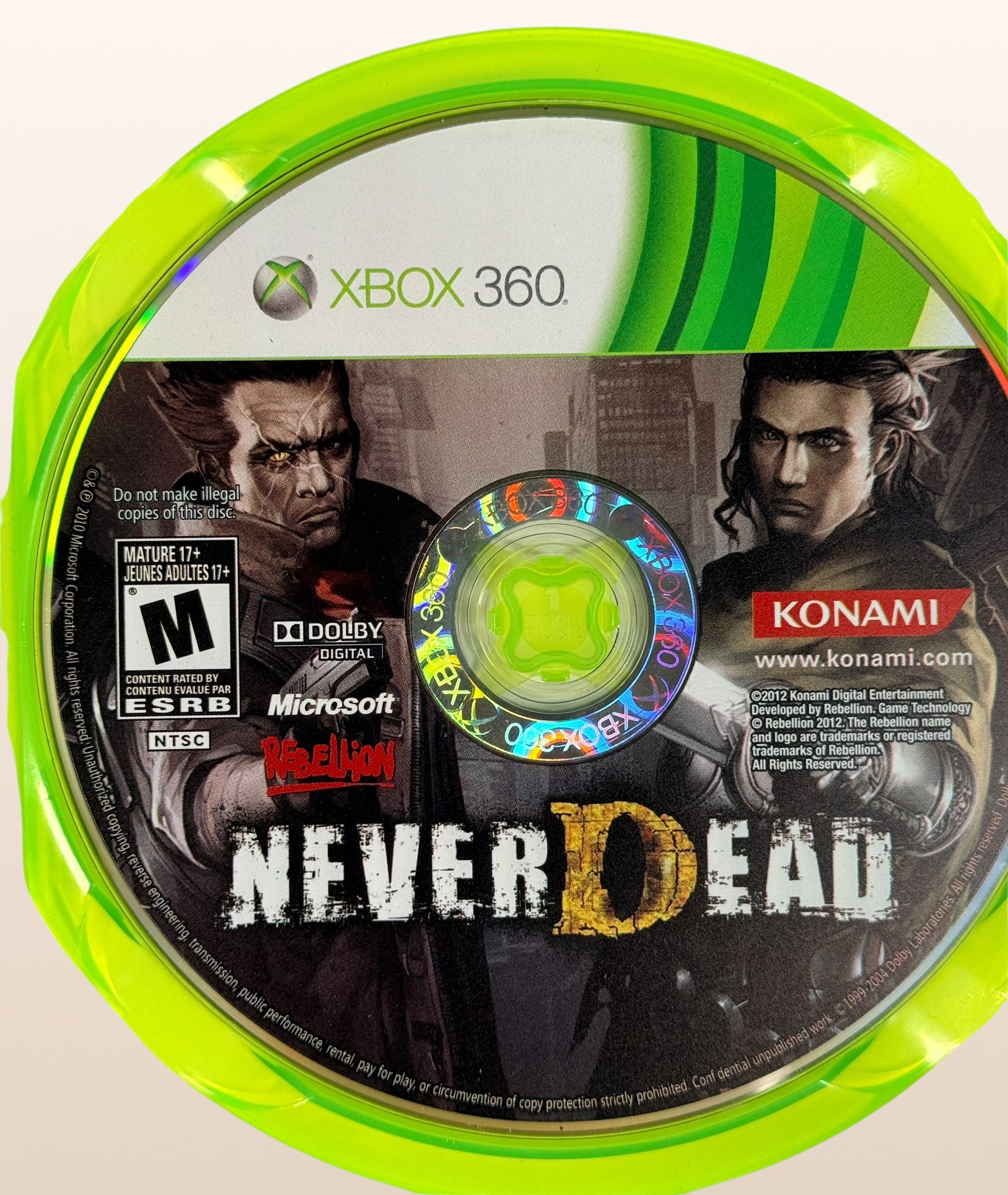 NeverDead for Xbox 360 by Konami. Cult action horror shooter with unique gameplay mechanics. Includes original case and disc in very good condition.
