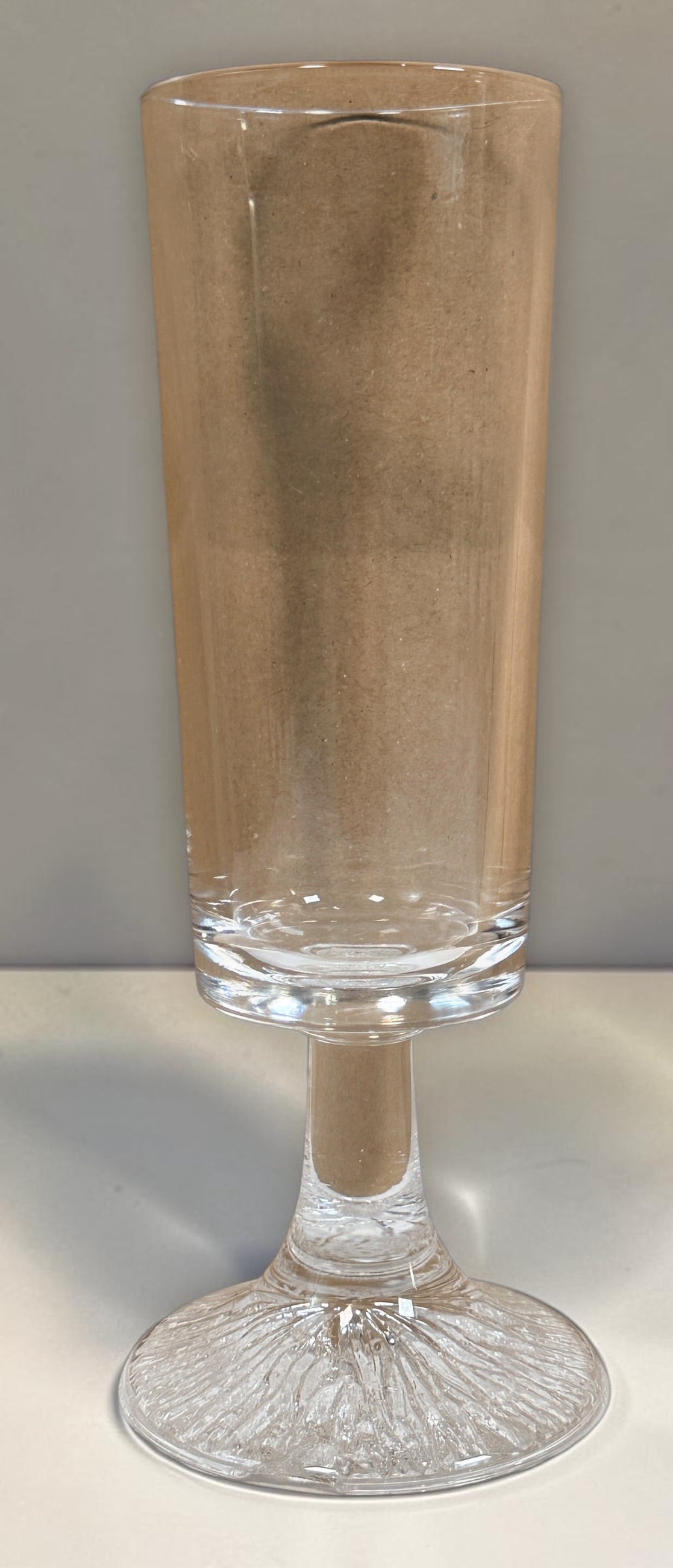 Vintage Finnish Iittala-style champagne flute with textured ice-effect base. Scandinavian Modern clear glassware, sold individually.