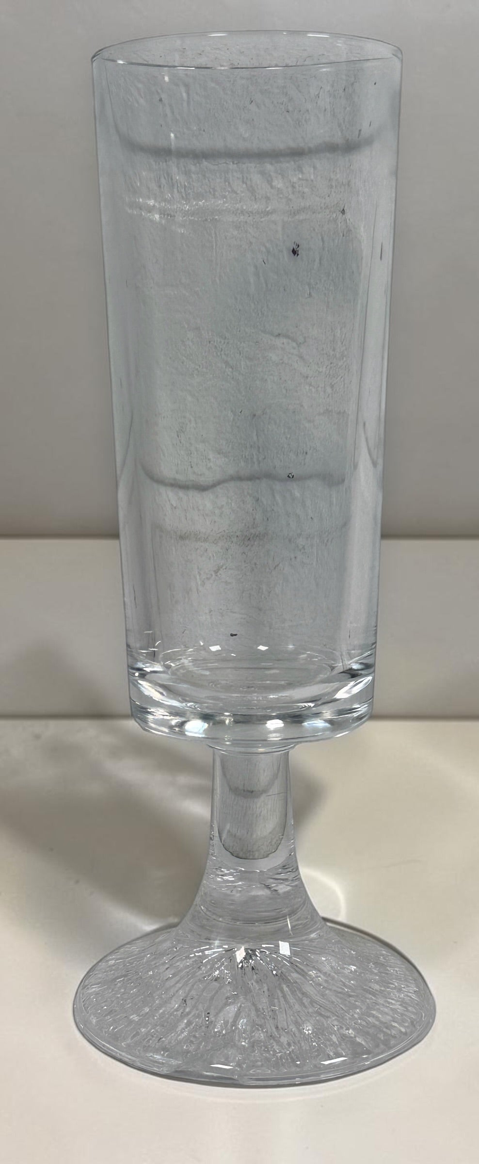 Vintage Finnish Iittala-style champagne flute with textured ice-effect base. Scandinavian Modern clear glassware, sold individually.