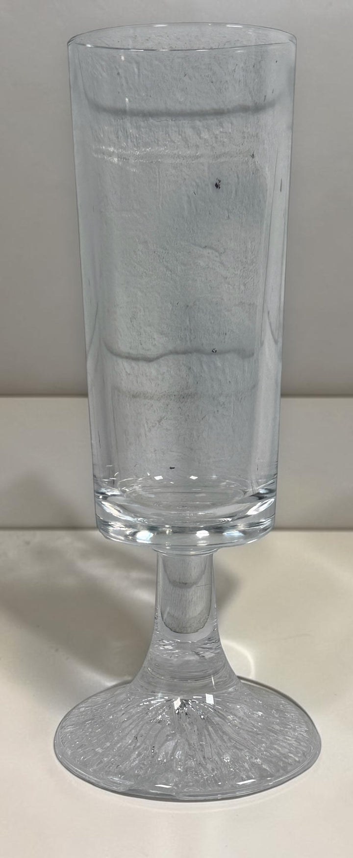 Vintage Finnish Iittala-style champagne flute with textured ice-effect base. Scandinavian Modern clear glassware, sold individually.