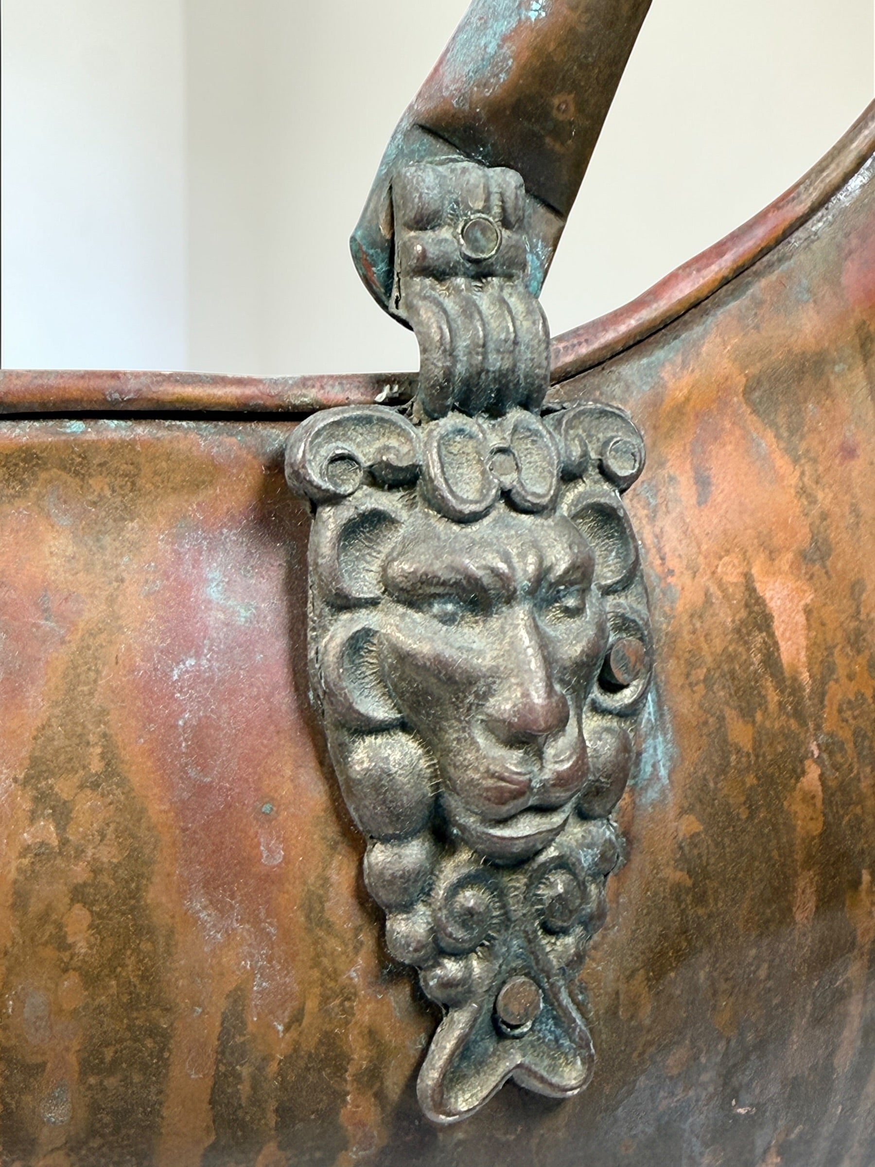 Vintage copper coal scuttle with lion head handles and ceramic grips. Classic fireplace log bucket with rich patina, perfect for rustic or traditional décor. 🔥