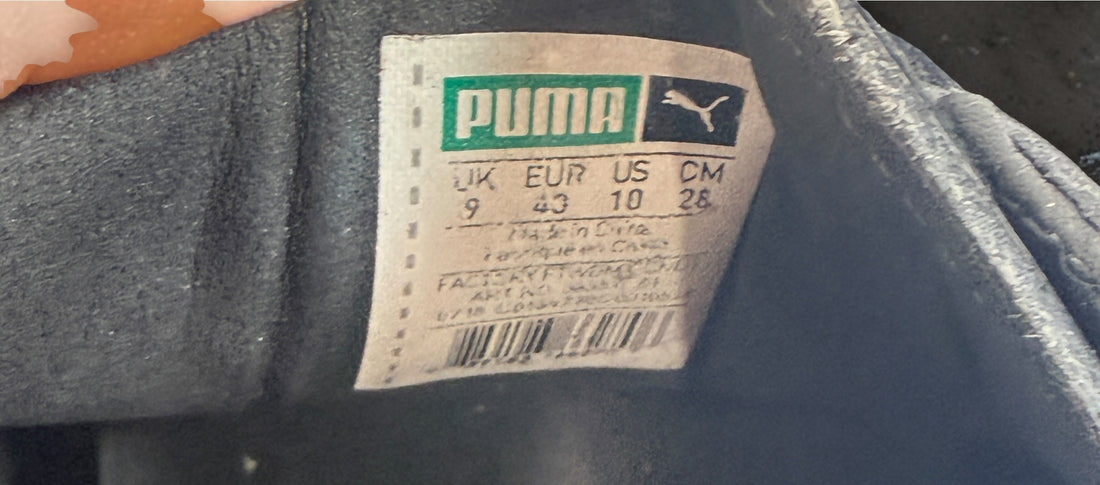 PUMA Clyde black patent-style men’s sneakers, US 10 / EU 43, featuring gold Clyde branding, tonal Formstrip and classic low-top styling.