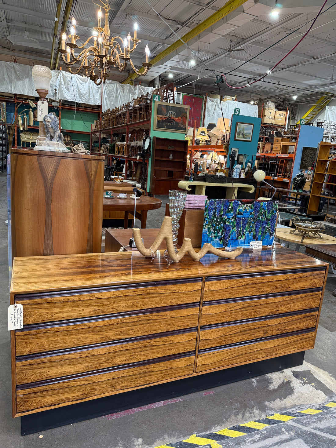 Vintage MCM rosewood lowboy dresser with 8 drawers and Danish modern styling. Large mid-century storage piece with stunning figured grain and clean lines.