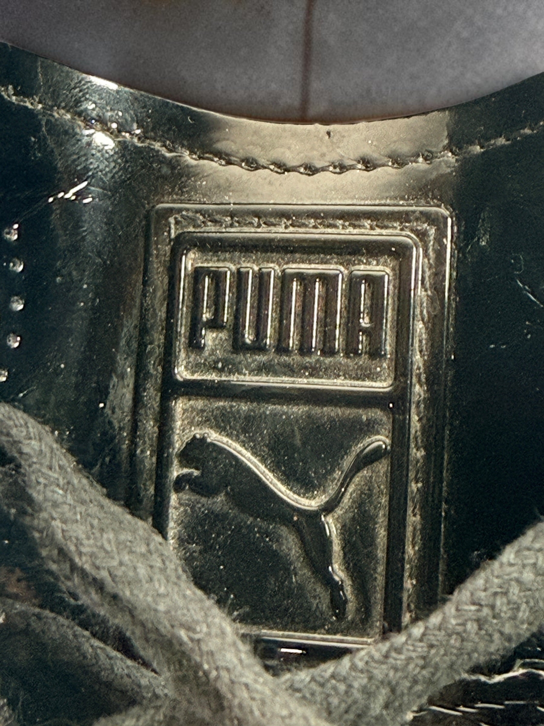 PUMA Clyde black patent-style men’s sneakers, US 10 / EU 43, featuring gold Clyde branding, tonal Formstrip and classic low-top styling.