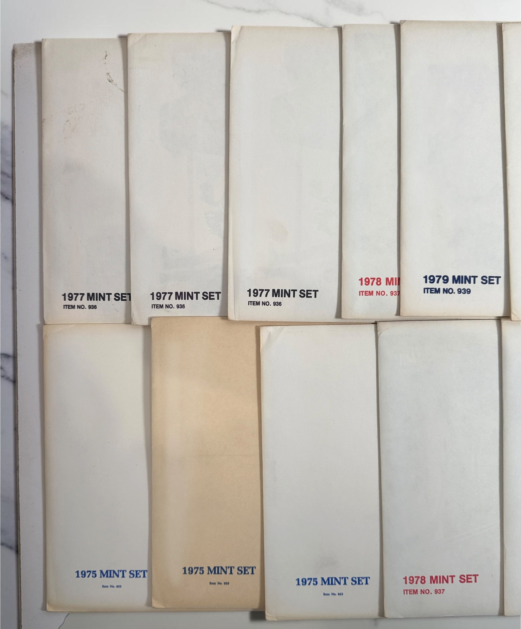 Vintage lot of 14 USPS Mint Sets of Commemorative Stamps from 1975–1979 with original stamps and presentation materials. Collectible U.S. postal history.