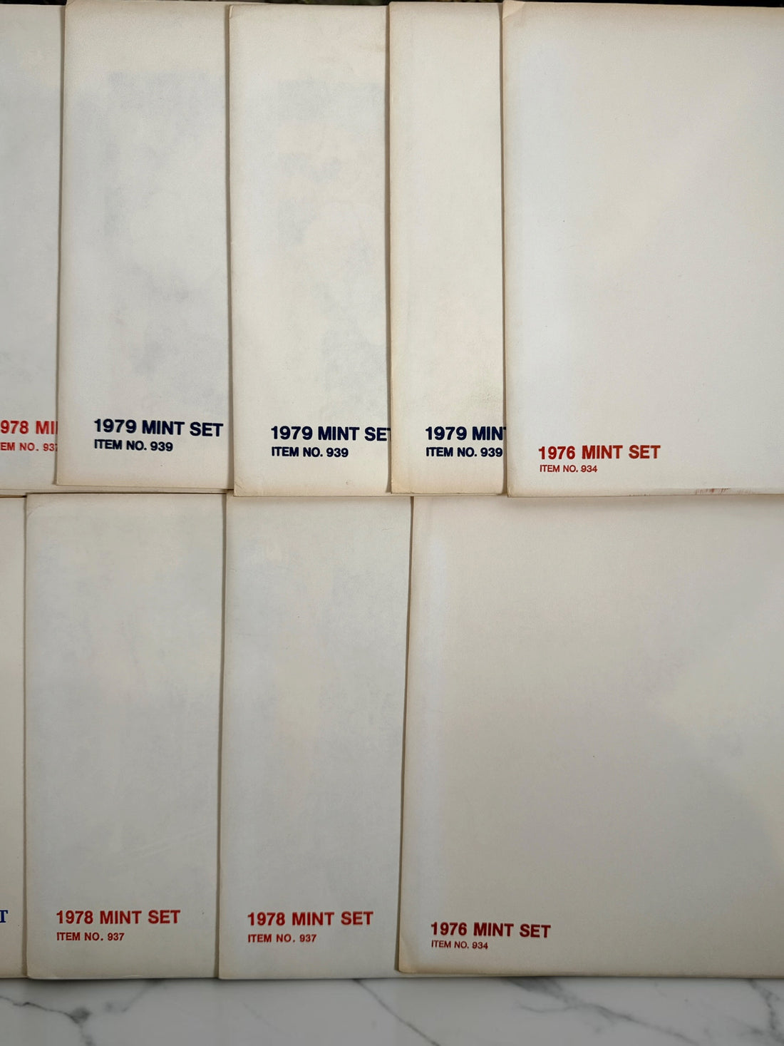 Vintage lot of 14 USPS Mint Sets of Commemorative Stamps from 1975–1979 with original stamps and presentation materials. Collectible U.S. postal history.