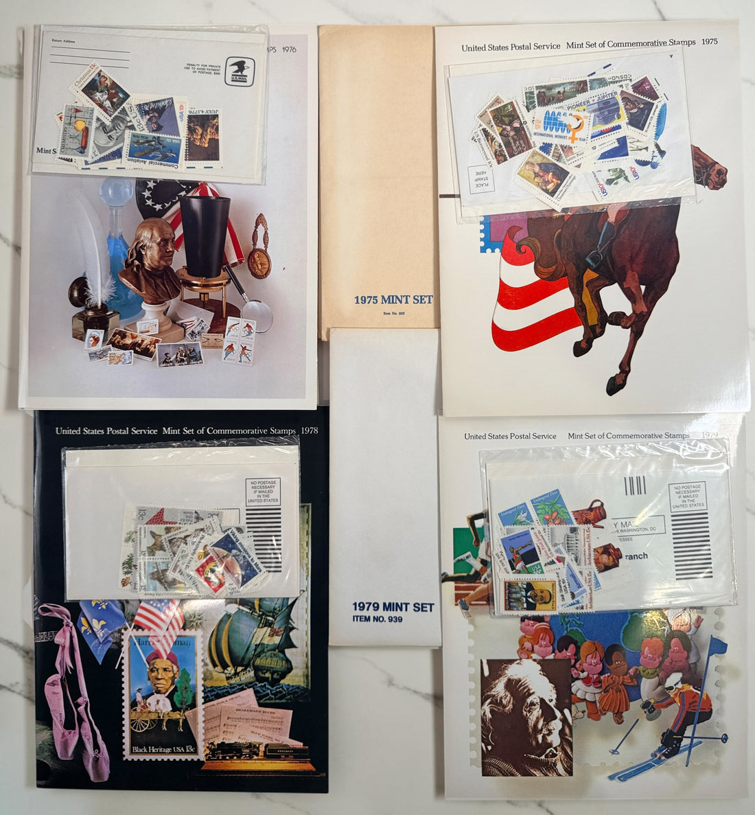 Vintage lot of 14 USPS Mint Sets of Commemorative Stamps from 1975–1979 with original stamps and presentation materials. Collectible U.S. postal history.