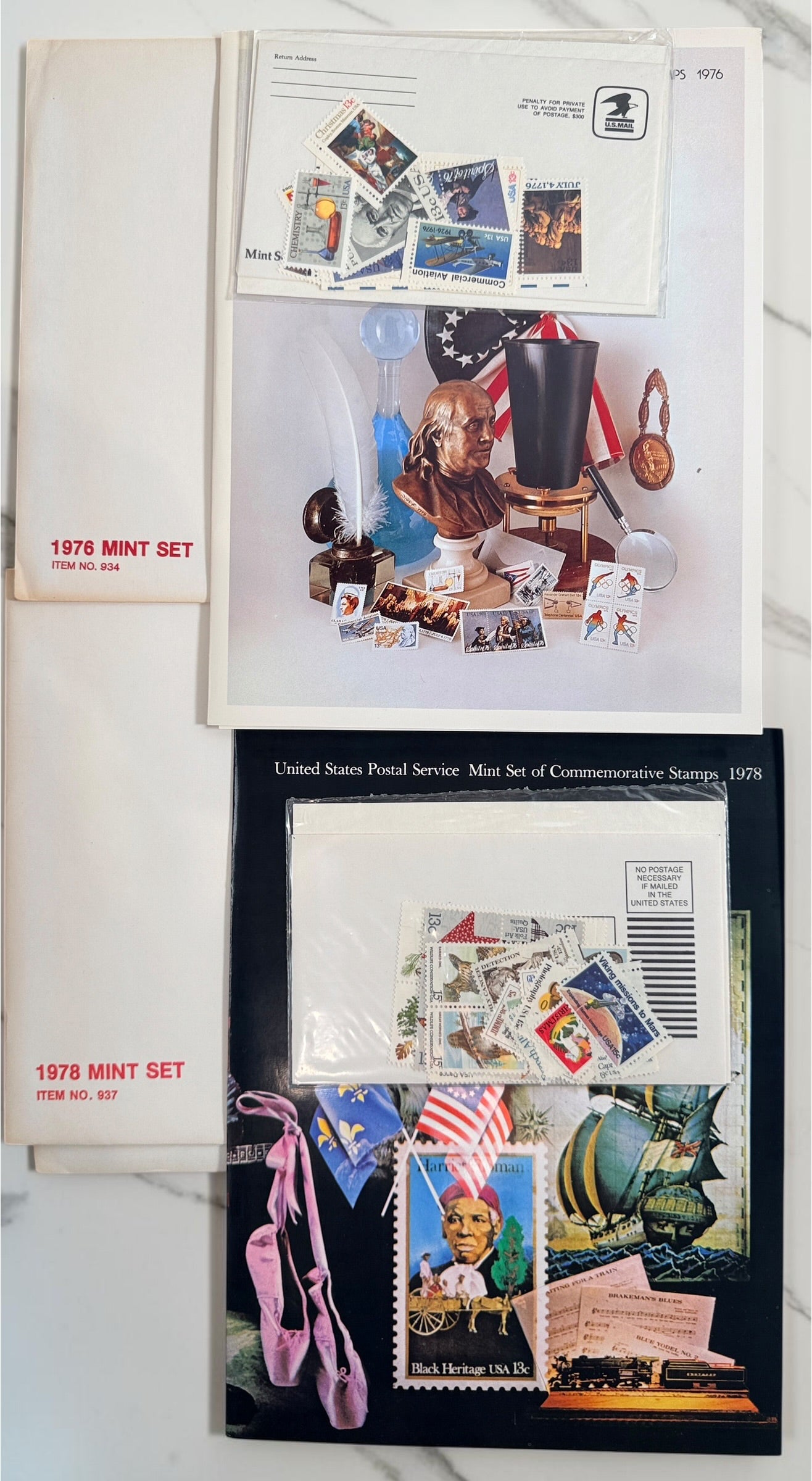 Vintage lot of 14 USPS Mint Sets of Commemorative Stamps from 1975–1979 with original stamps and presentation materials. Collectible U.S. postal history.