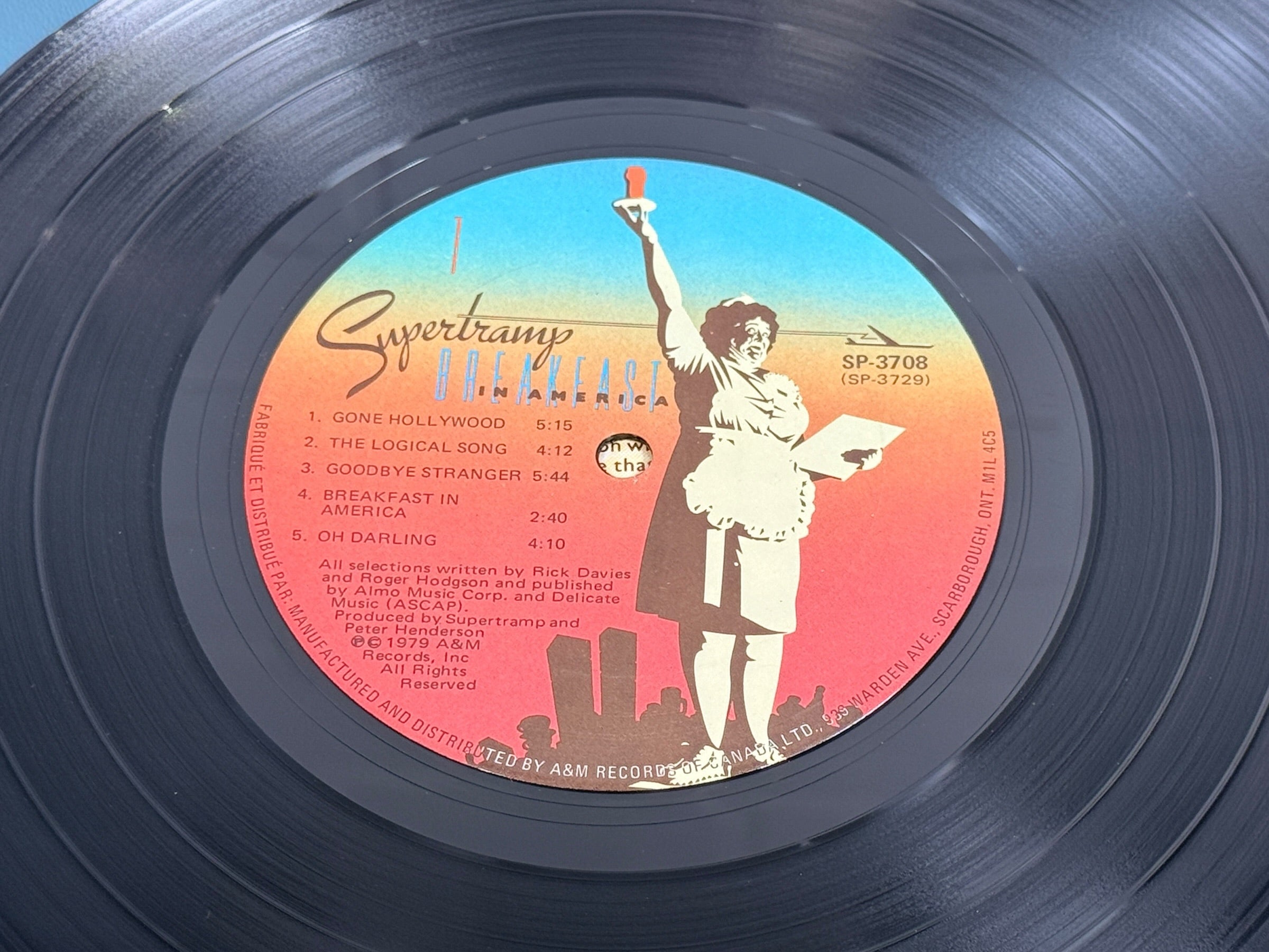 Supertramp's Breakfast in America (1979) Canadian vinyl LP on A&M Records SP-3708. Original lyric sleeve included. Vintage classic rock record.