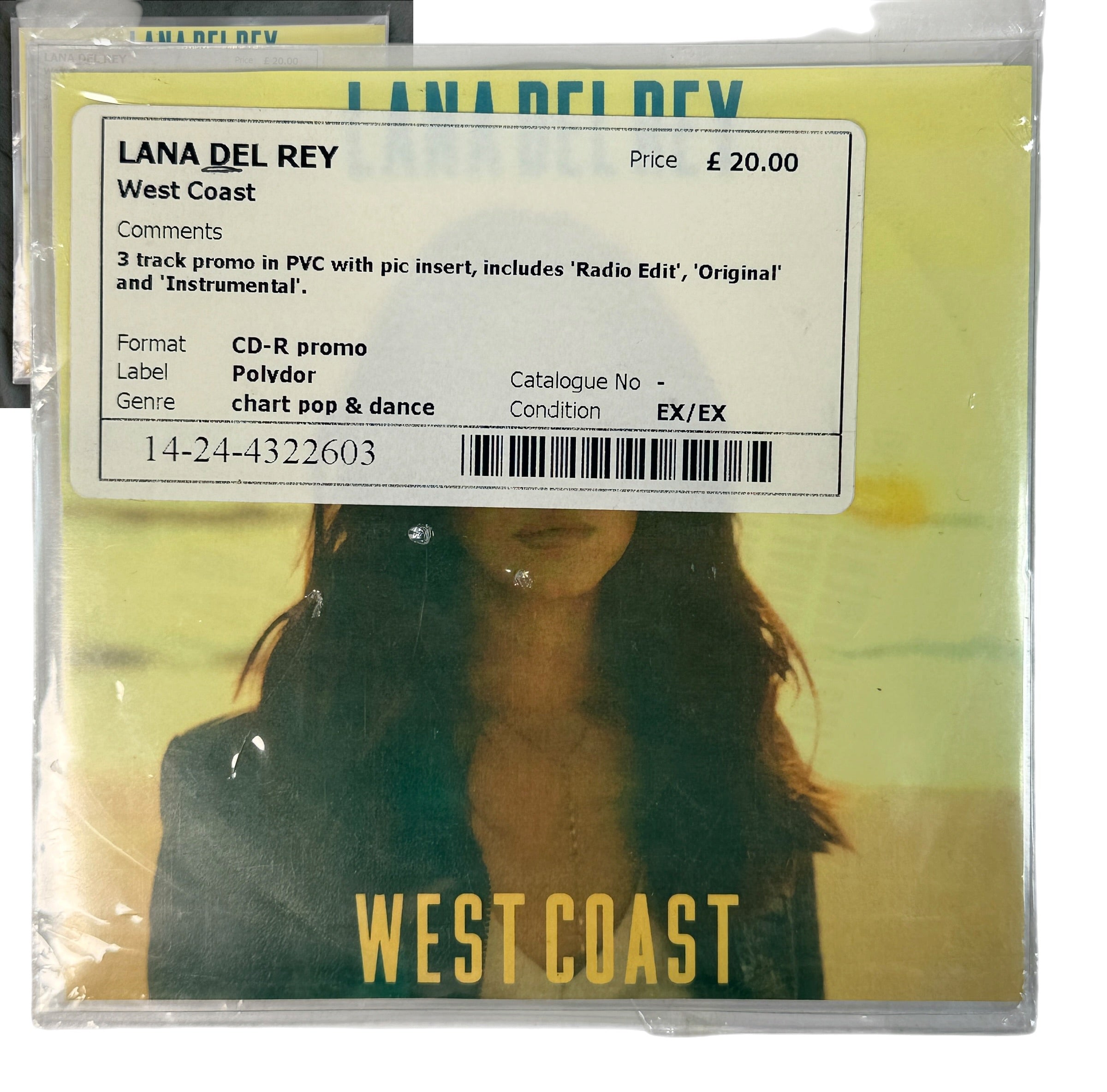 Lana Del Rey 'West Coast' CD-R promo single cover in clear plastic shrink wrap, with a white track information sticker overlaid on the front. The cover art features a yellow-green gradient background with a blurred portrait of Lana Del Rey and bold yellow 'WEST COAST' text at the bottom.