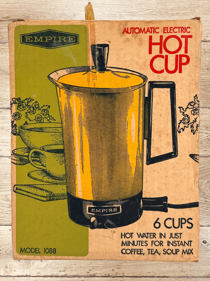 
Vintage Empire Electric Hot Cup Model 1088 avocado green travel kettle with original box. Mid-century portable electric water heater by Metal Ware Corp.