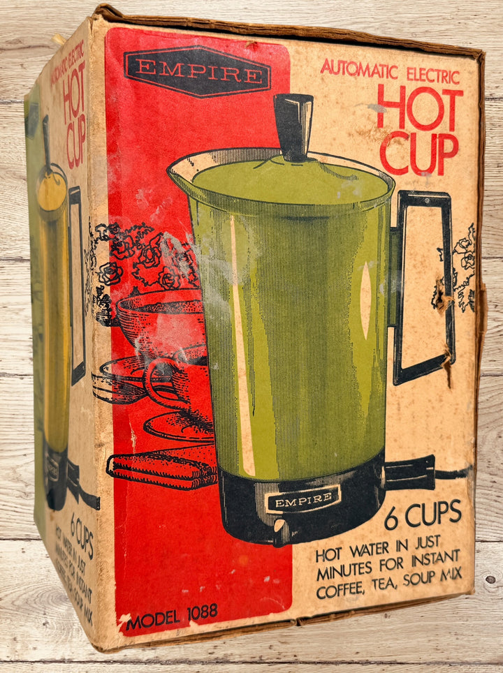 
Vintage Empire Electric Hot Cup Model 1088 avocado green travel kettle with original box. Mid-century portable electric water heater by Metal Ware Corp.