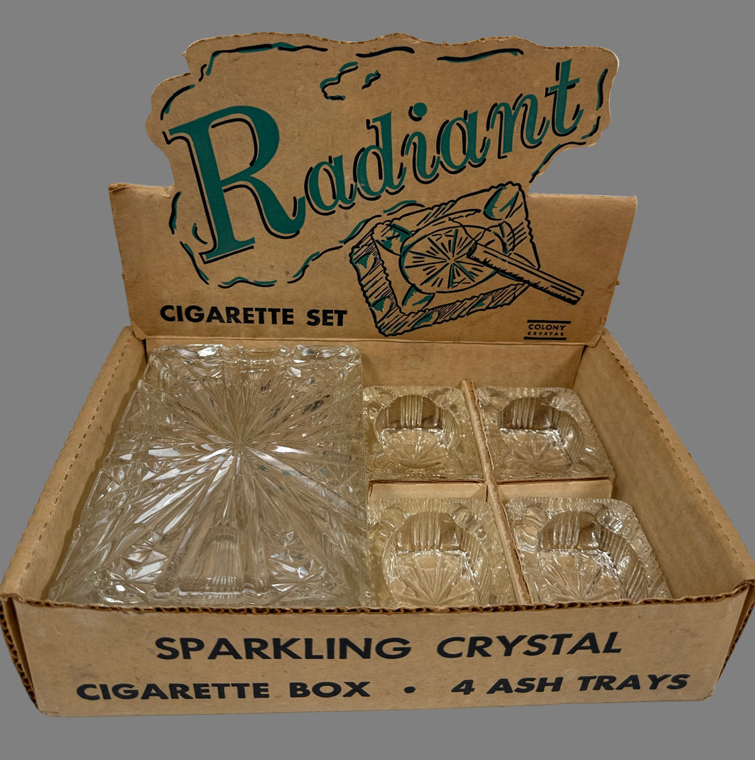 Box of 'Radiant' sparkling crystal cigarette set with ash trays on a white background