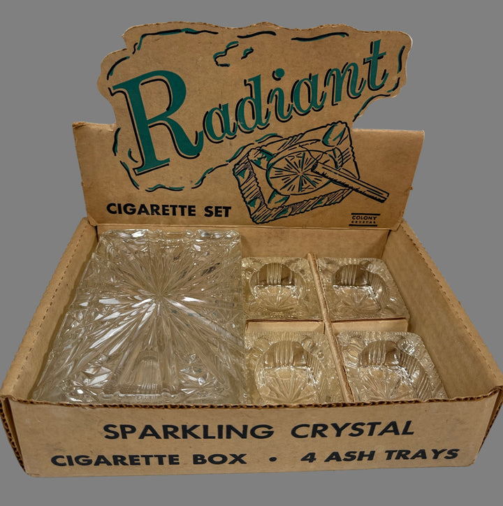 Box of 'Radiant' sparkling crystal cigarette set with ash trays on a white background