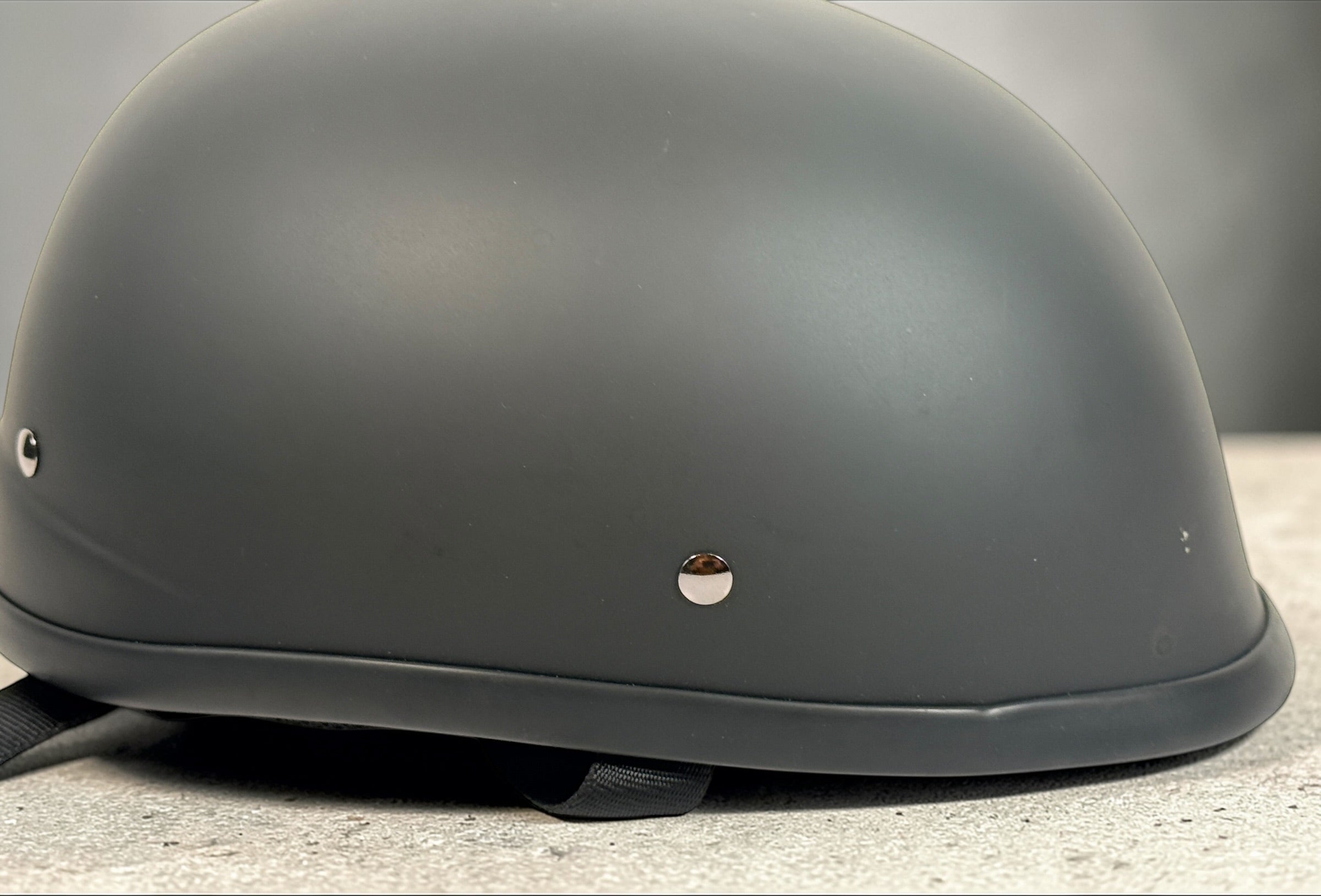 X-Terminator classic matte black motorcycle half helmet size XS with padded liner and quick release strap. Lightweight German style cruiser helmet.