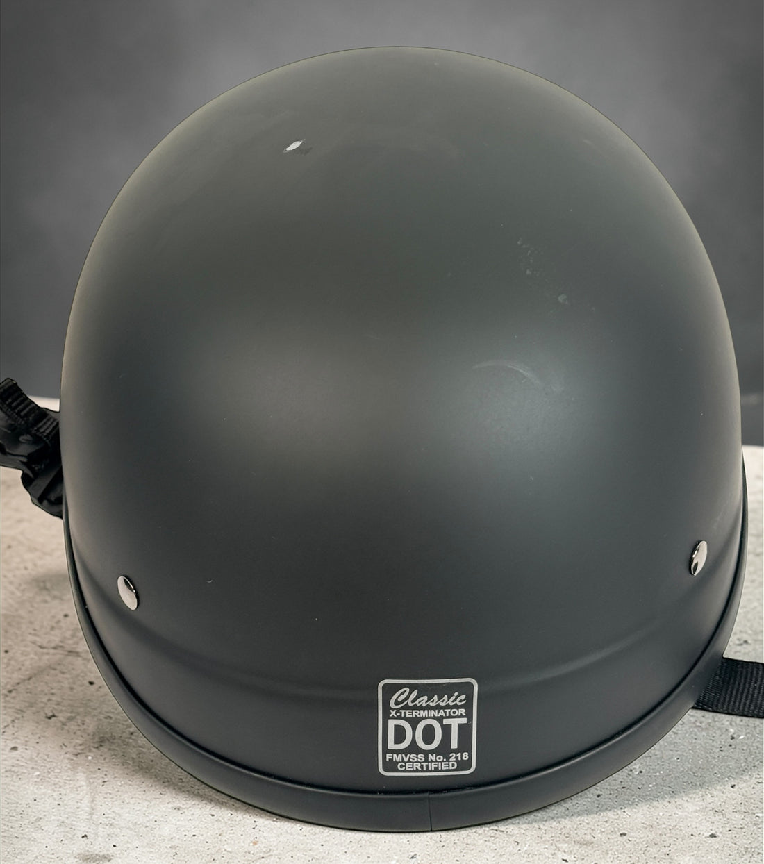 X-Terminator classic matte black motorcycle half helmet size XS with padded liner and quick release strap. Lightweight German style cruiser helmet.