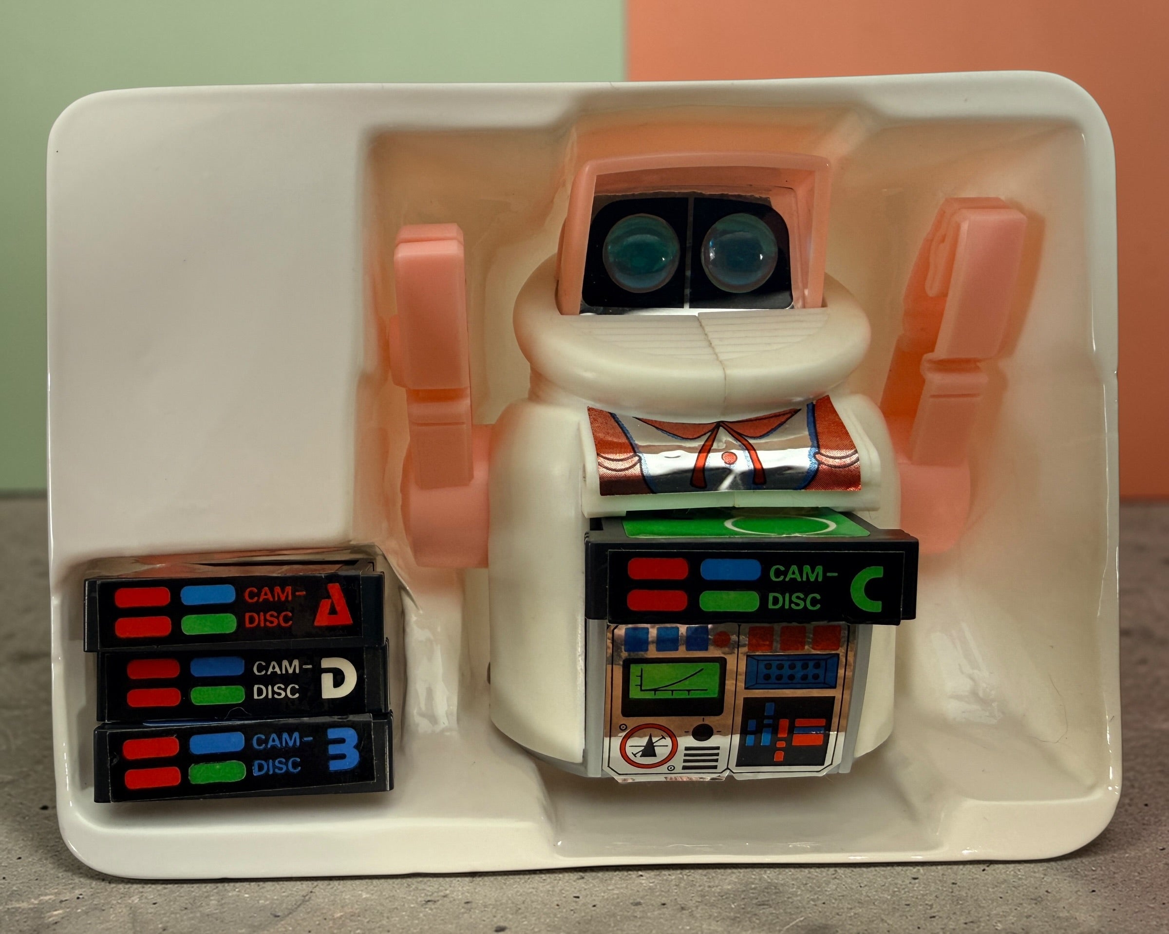 Vintage 1980s Disc Bot programmable toy robot with Disc Cam cartridges and original box. Battery operated retro robot toy made in Hong Kong.