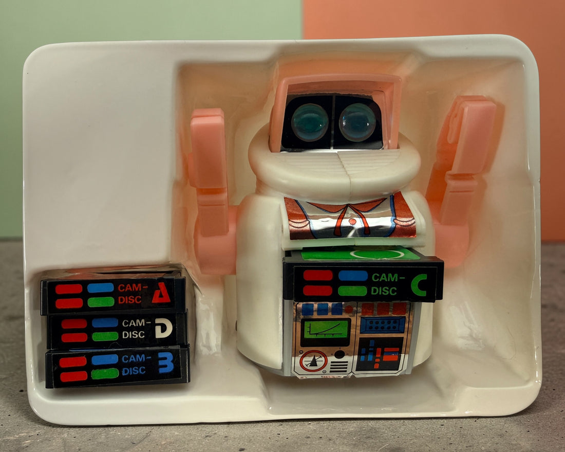 Vintage 1980s Disc Bot programmable toy robot with Disc Cam cartridges and original box. Battery operated retro robot toy made in Hong Kong.