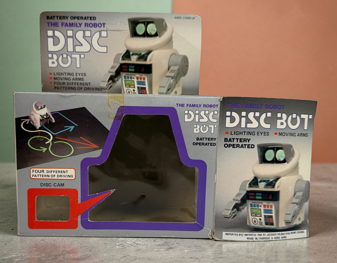 Vintage 1980s Disc Bot programmable toy robot with Disc Cam cartridges and original box. Battery operated retro robot toy made in Hong Kong.