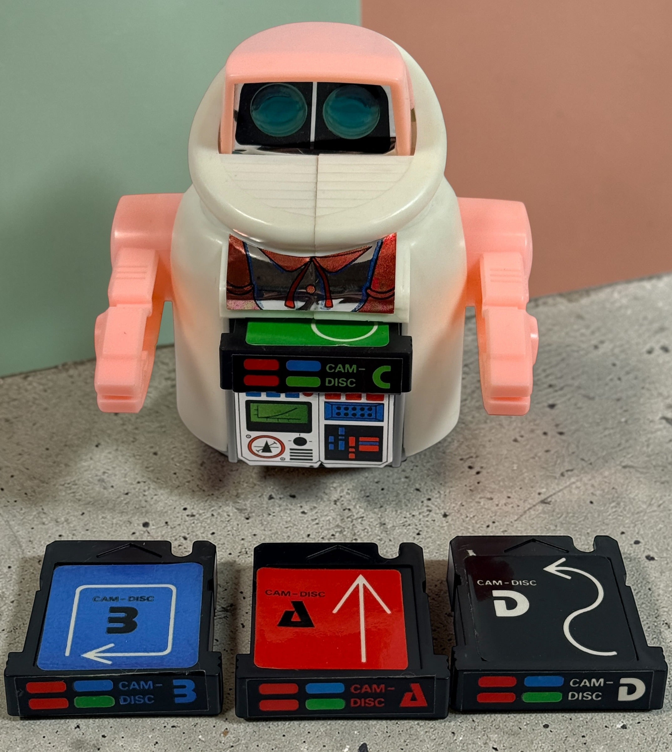 Vintage 1980s Disc Bot programmable toy robot with Disc Cam cartridges and original box. Battery operated retro robot toy made in Hong Kong.