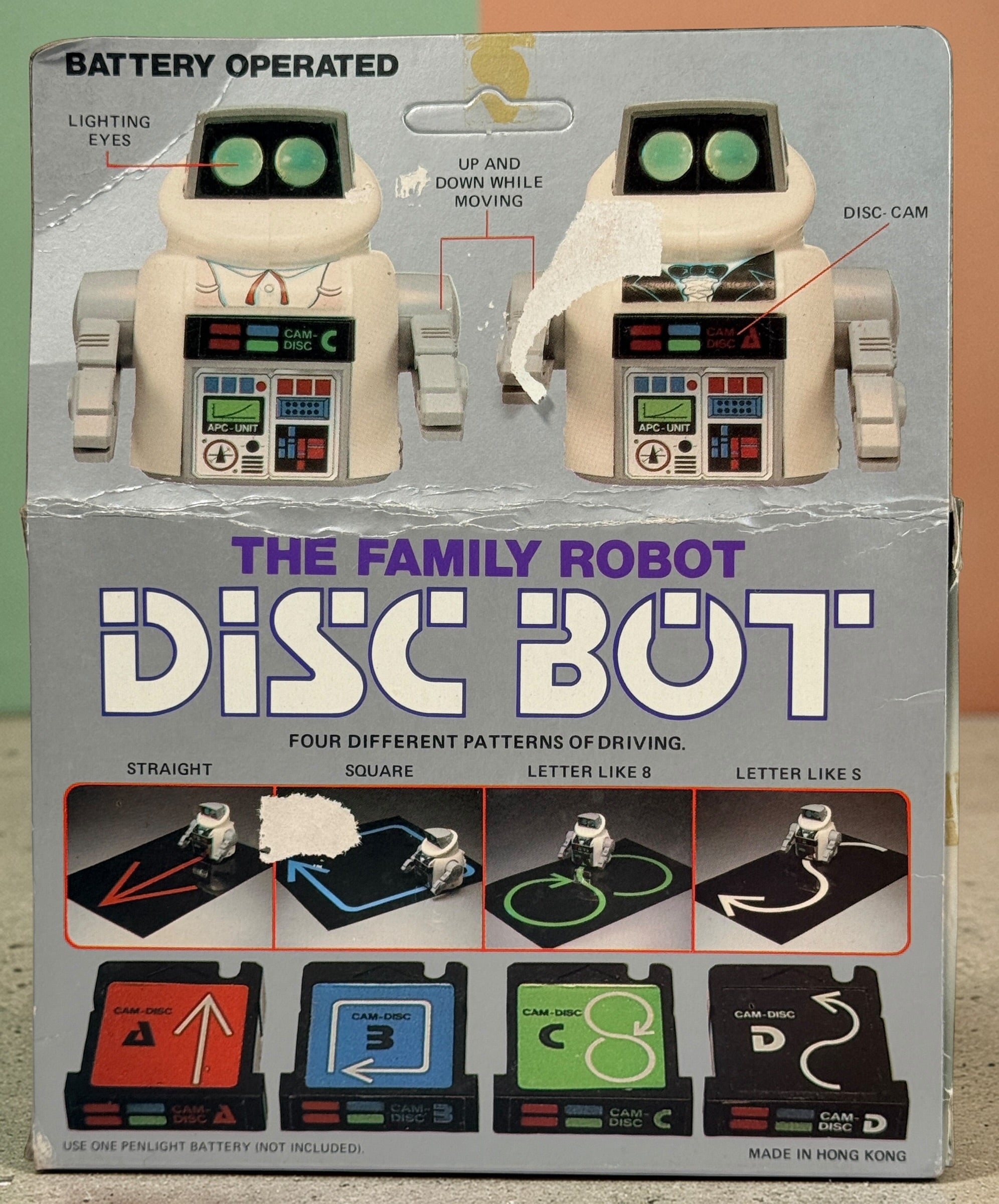 Vintage 1980s Disc Bot programmable toy robot with Disc Cam cartridges and original box. Battery operated retro robot toy made in Hong Kong.