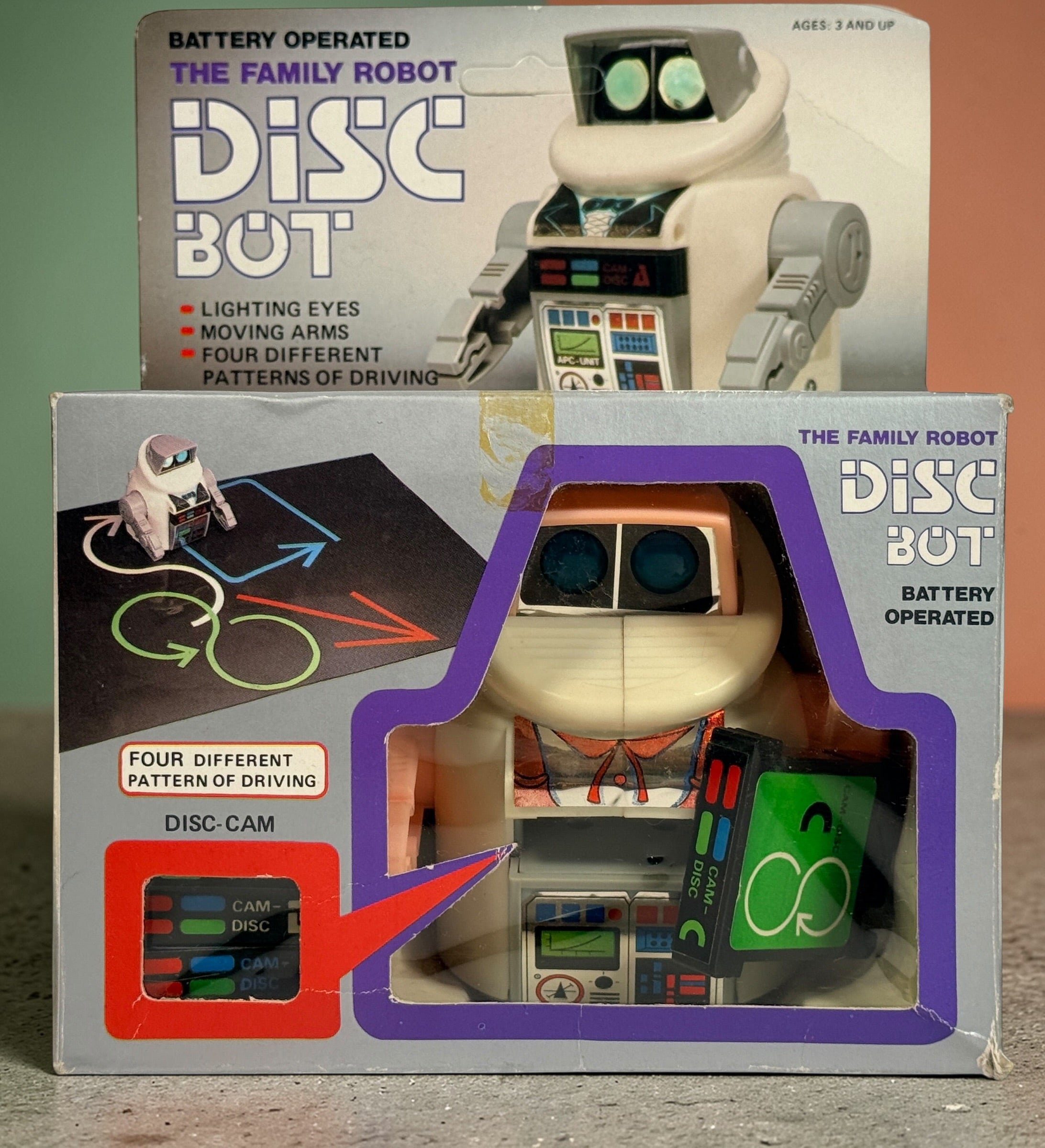 Vintage 1980s Disc Bot programmable toy robot with Disc Cam cartridges and original box. Battery operated retro robot toy made in Hong Kong.
