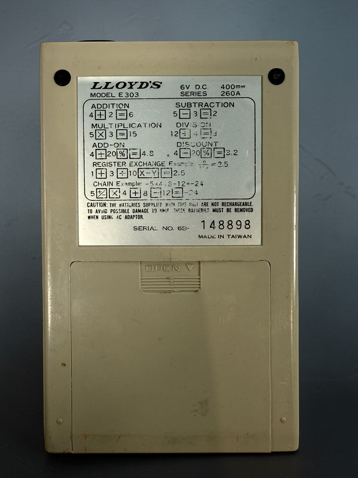 Vintage Lloyd’s Accumatic 303 LED desktop calculator from the 1970s. Classic retro electronic calculator with working display, perfect for collectors or decor.
