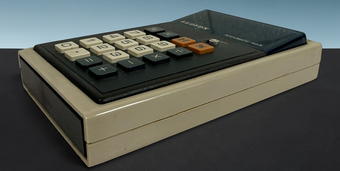 Vintage Lloyd’s Accumatic 303 LED desktop calculator from the 1970s. Classic retro electronic calculator with working display, perfect for collectors or decor.
