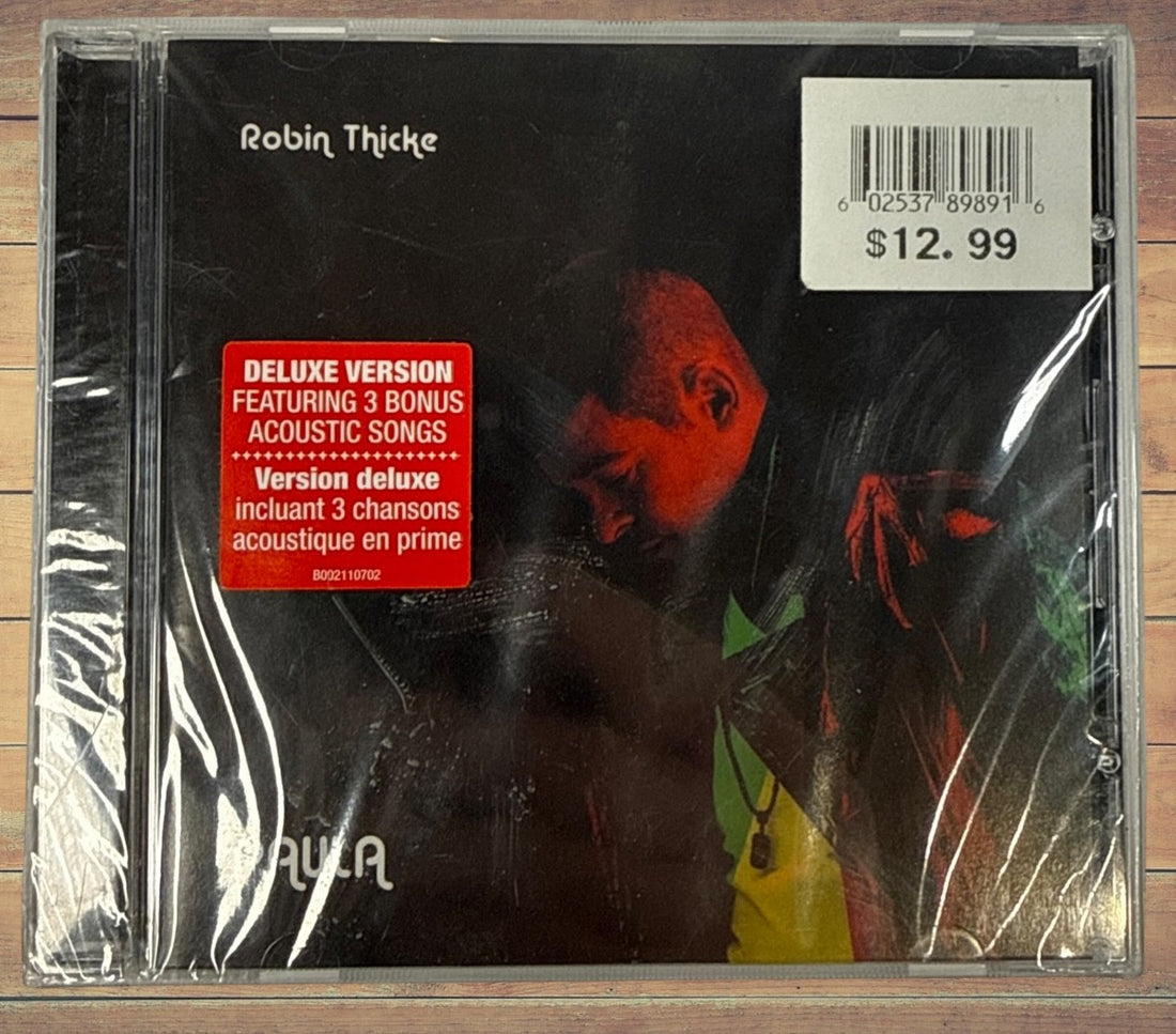 Sealed deluxe CD edition of Robin Thicke’s 2014 album Paula featuring three acoustic bonus tracks. Original retail copy in shrink wrap with jewel case.